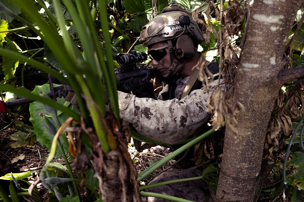 U.S. Marine Lance Cpl. Trevor Dillard, an infantry Marine with Battalion Landing Team 2/1, 31st Marine Expeditionary Unit, provides suppressing fire during a boat raid exercise at the Kin Red training area