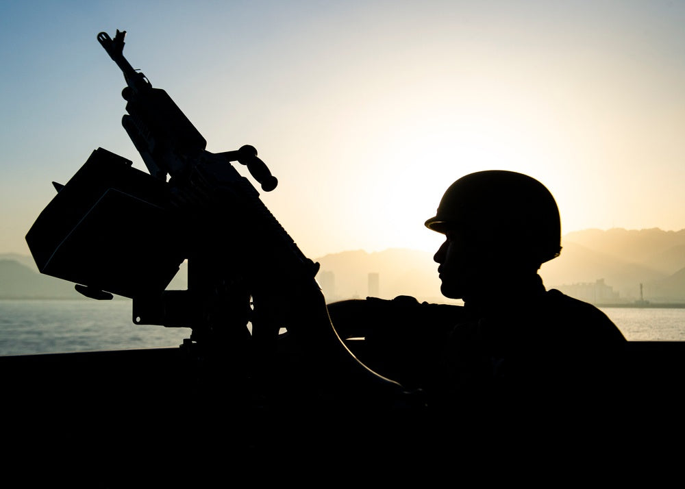 U.S. Navy Fireman Jorge Quirarte mans a M240 machine gun aboard guided-missile destroyer USS Paul Hamilton