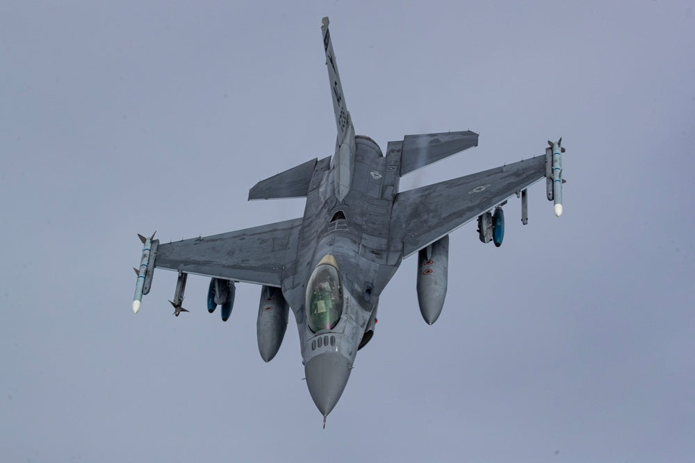 A U.S. Air Force F-16C Fighting Falcon with the 177th Fighter Wing flies behind a 108th Wing KC-135R Stratotanker during a refueling mission