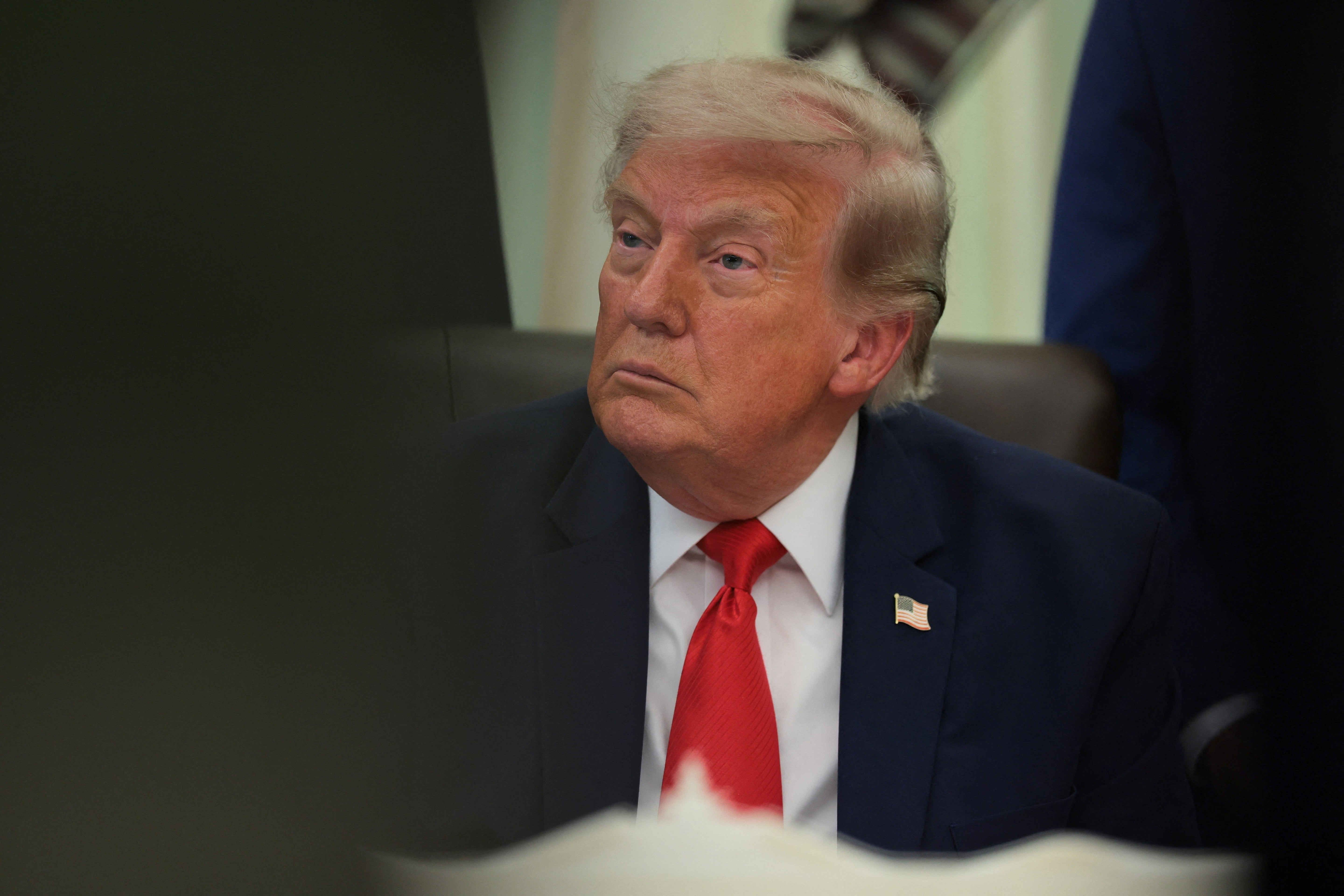 U.S. President Donald Trump sits behind an airport model as he makes an announcement about a $22.5 billion renovation of Washington Dulles International Airport with U.S. Secretary of Transportation Sean Duffy (not pictured) in the Oval Office at the