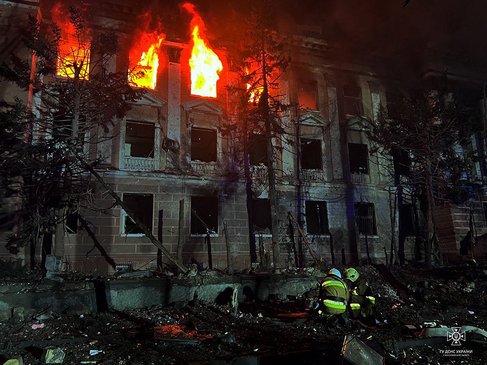 Firefighters work at a site of a building damaged by a Russian missile strike, amid Russia's attack on Ukraine
