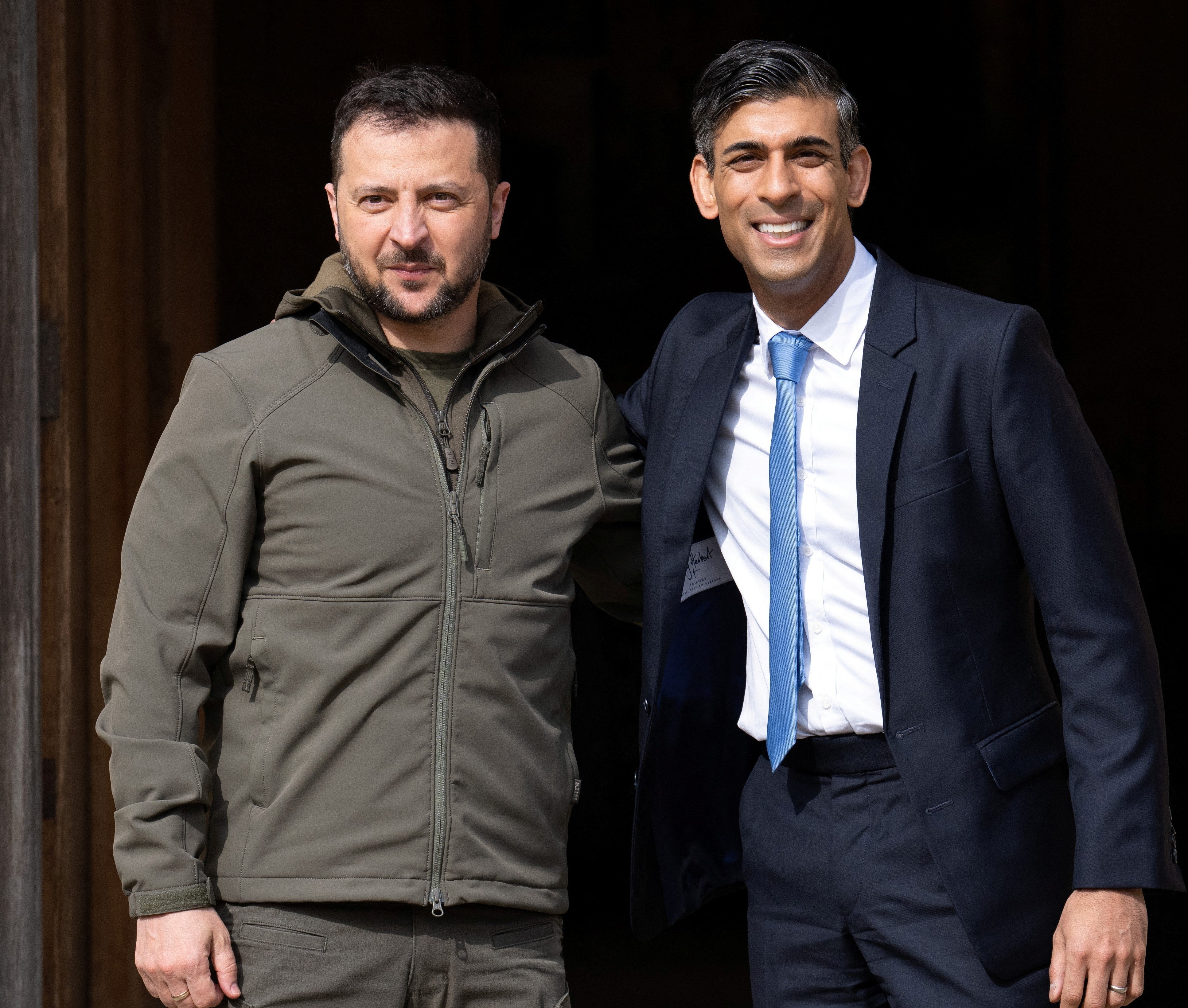 Britain's Prime Minister, Rishi Sunak (R), greets Ukraine's President, Volodymyr Zelenskiy,