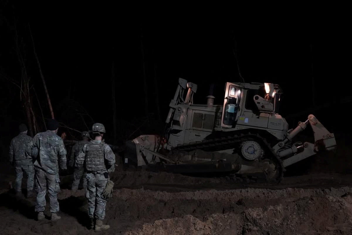Crews dig for soldiers' submerged vehicle in Lithuania