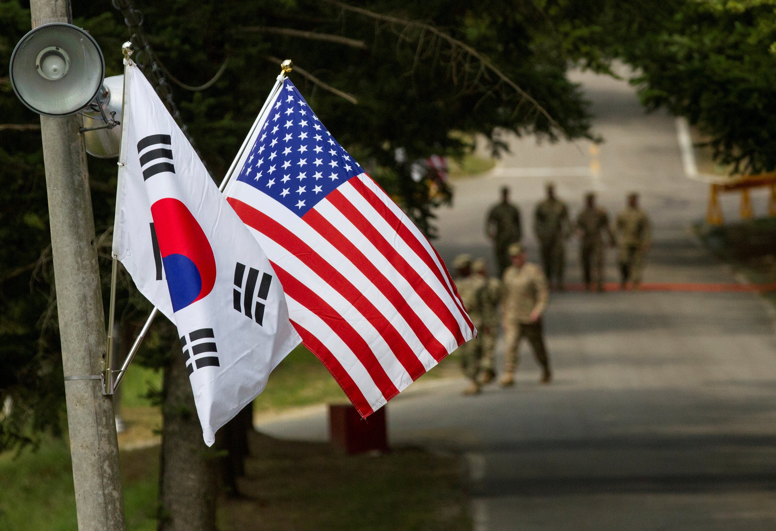The South Korean and American flags fly next to each other at Yongin, South Korea