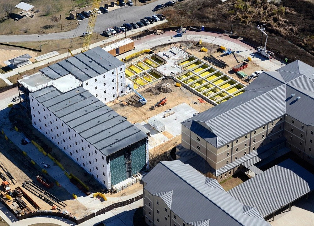 Medical Education and Training Campus dormitories at Fort Sam Houston are shown in a 2014 Army photograph. More than 5,000 military medical trainees were relocated from the complex in July 2026 after serious building problems, and the Air Force now says