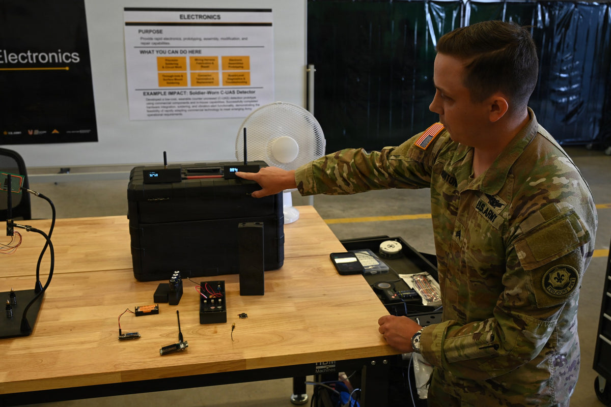 U.S. Army Sgt. Ryan Minton, assigned to the 2nd Cavalry Regiment, displays a custom wearable drone-detection device he designed and built at the 7th Army Training Command’s DIRT Lab in Germany, July 31, 2026. (U.S. Army photo by Kevin Sterling Payne)