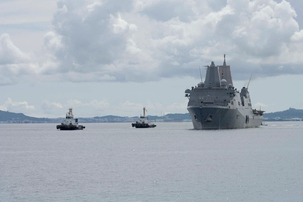 USS New Orleans returns under its own propulsion to White Beach Naval Facility in Okinawa on Aug. 22, 2025, two days after an 11-hour fire aboard the ship. A newly public Navy investigation found that ceiling-high stacks of toilet paper, unauthorized
