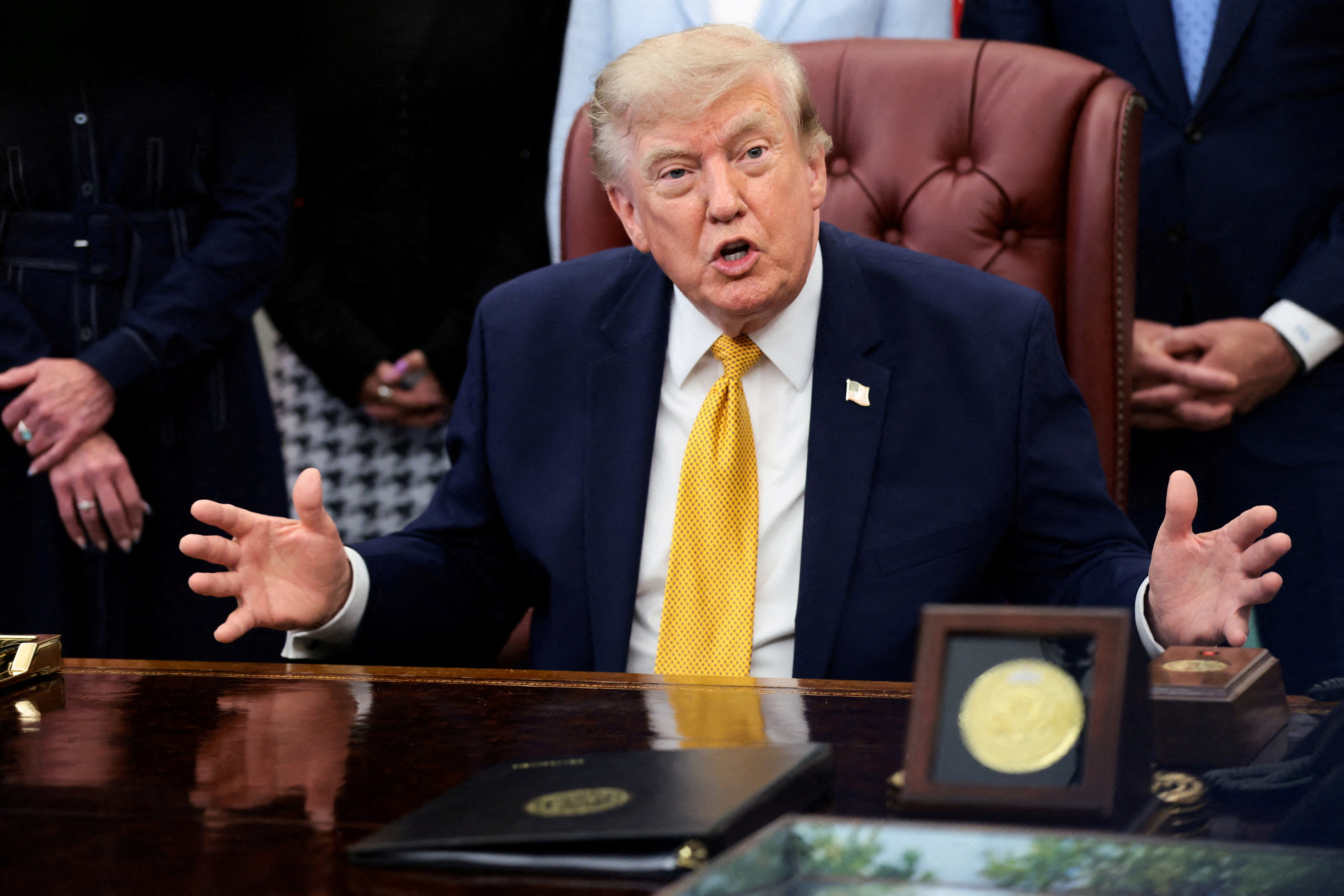 FILE PHOTO: U.S. President Donald Trump answers questions from the media after signing an executive order, in the Oval Office at the White House in Washington, D.C., U.S., August 3, 2026. REUTERS/Evelyn Hockstein/File Photo