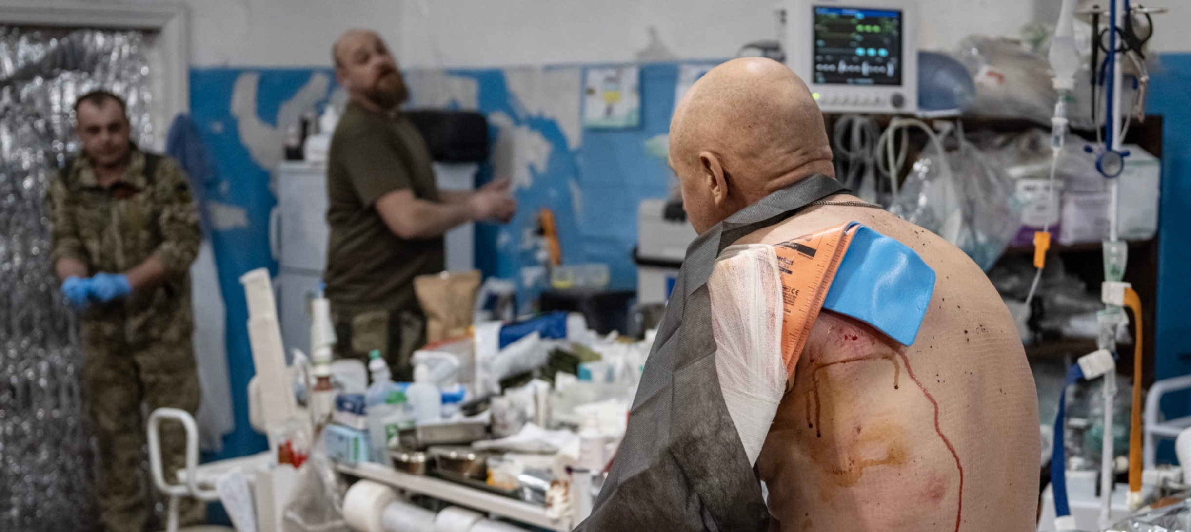 A wounded Ukrainian soldier sits on the operation table near Vuhledar