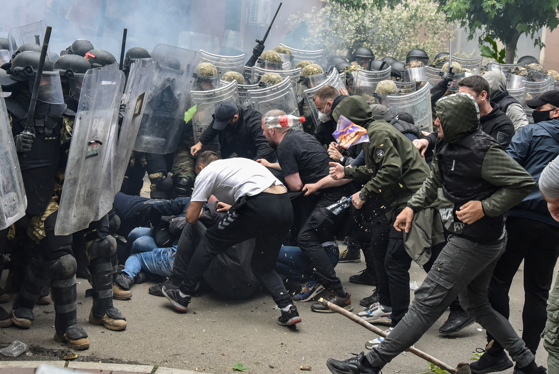 NATO Kosovo Force (KFOR) soldiers clash with local Kosovo Serb protesters at the entrance of the municipality office