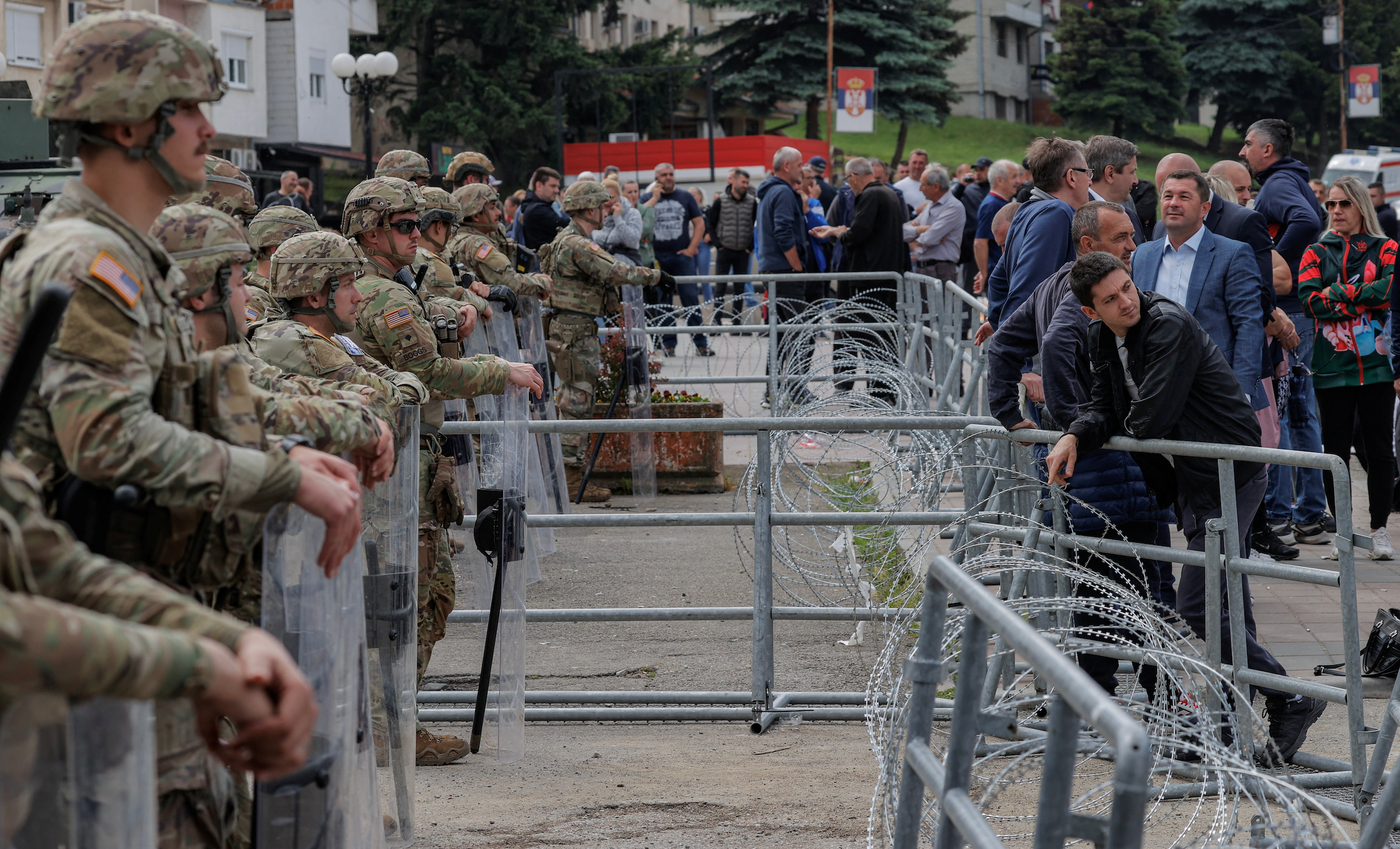 Kosovo Serbs protest as U.S. KFOR soldiers protect the entrance of the municipality office