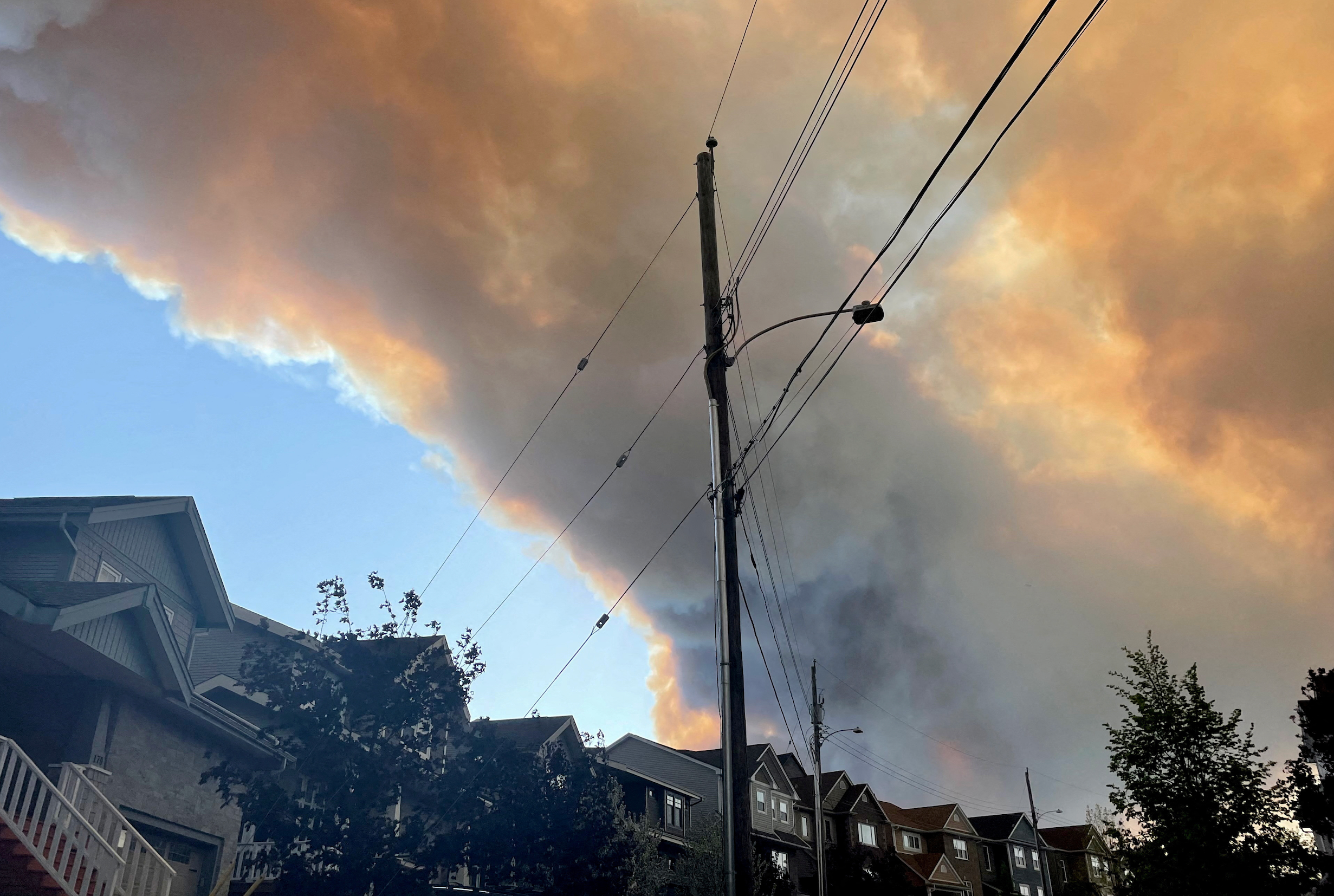 Smoke from the Tantallon wildfire rises over houses in nearby Bedford, Nova Scotia