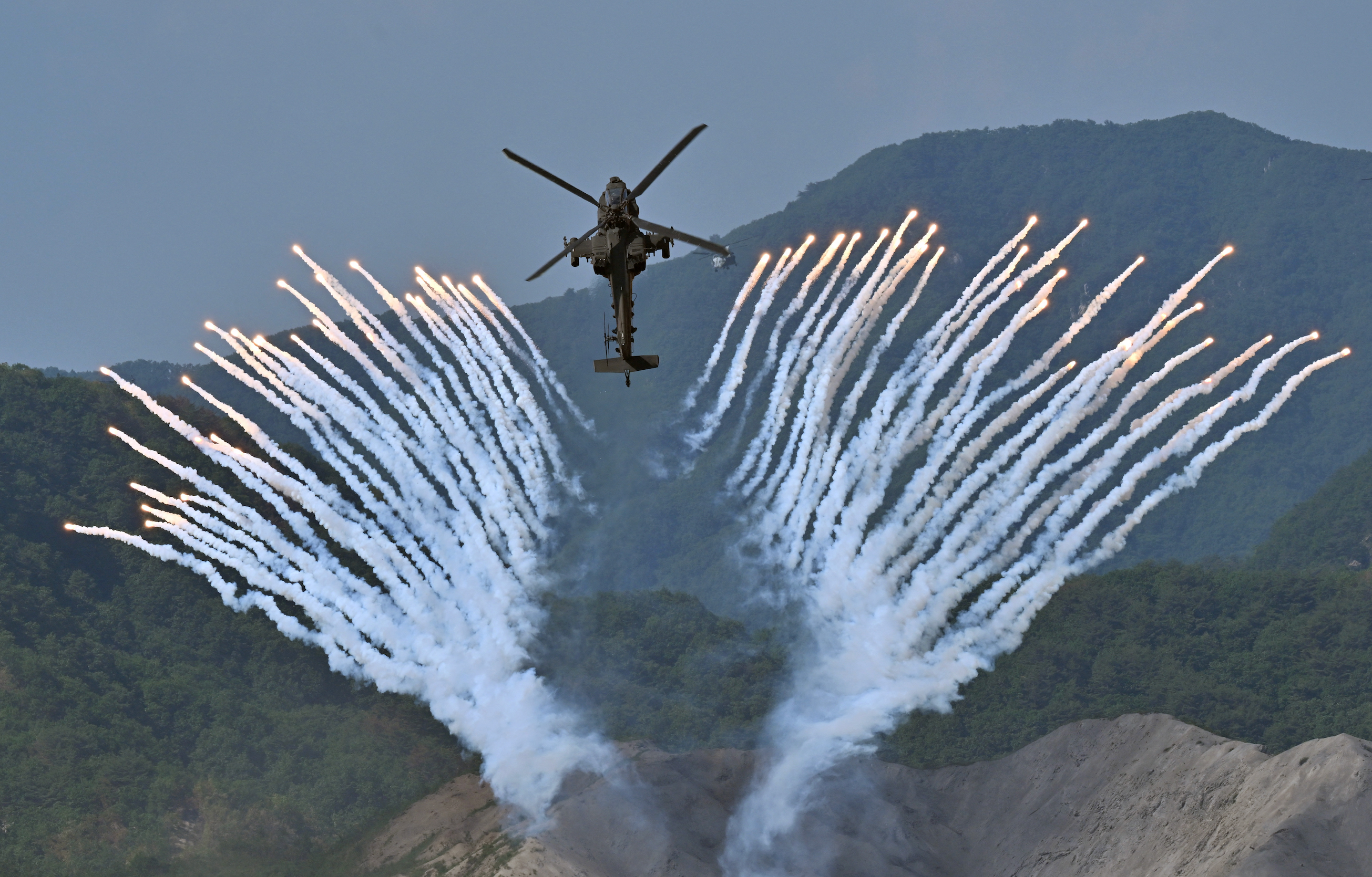 A South Korean Apache AH-64 helicopter fires flares during a South Korea-US joint military drill at Seungjin Fire Training Field
