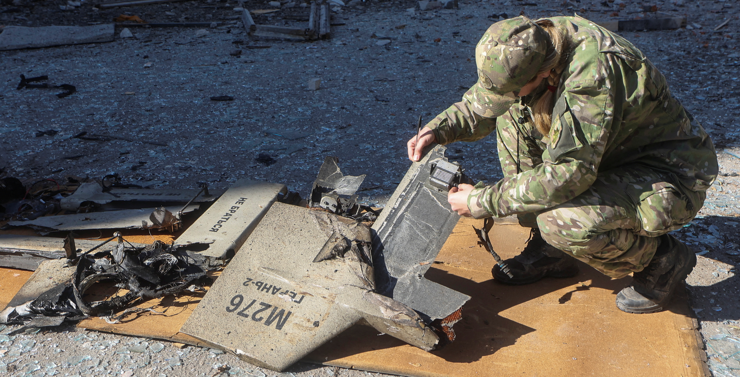 A police officer inspects parts of an unmanned aerial vehicle