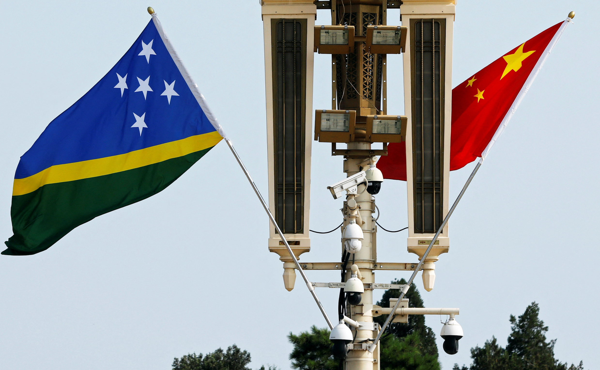 Flags of Solomon Islands and China flutter near the Tiananmen Gate
