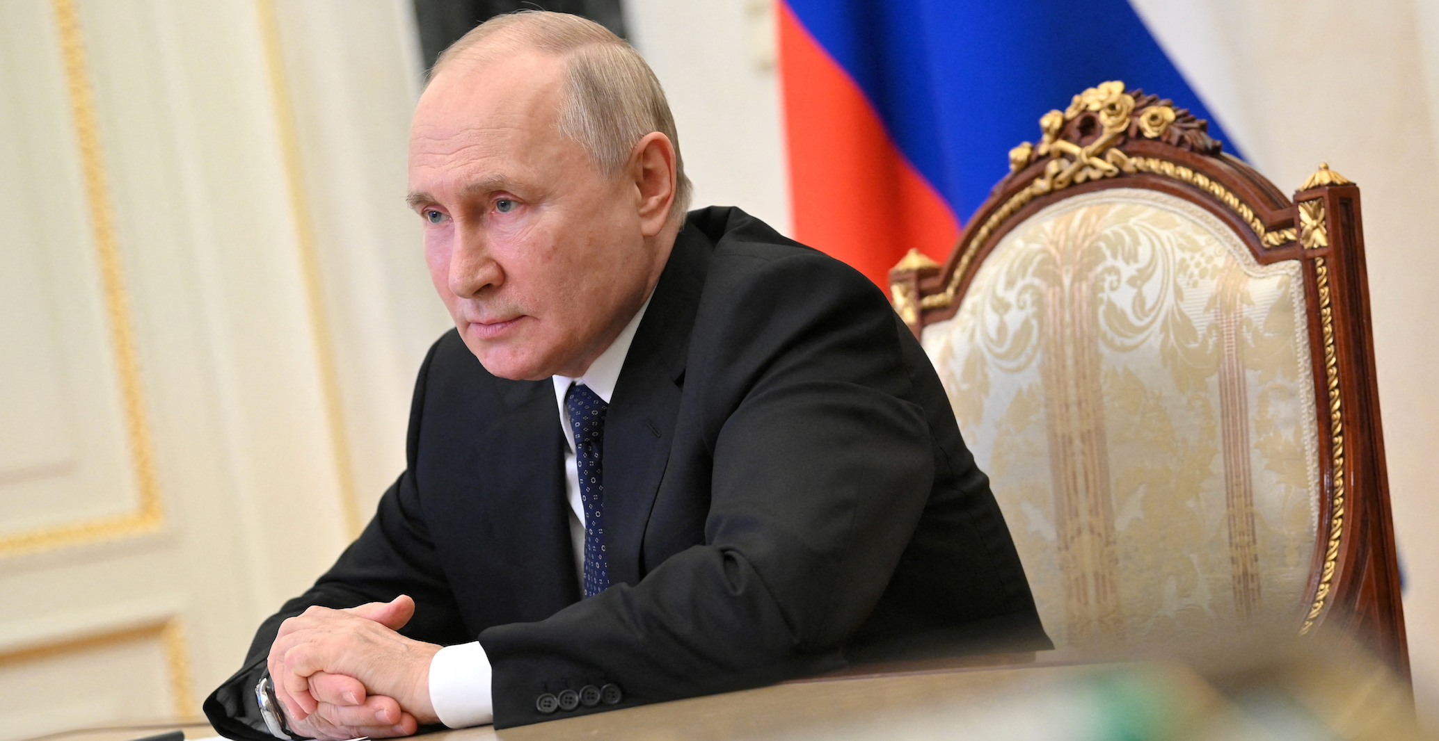 Russian President Vladimir Putin attends a televised meeting with officials