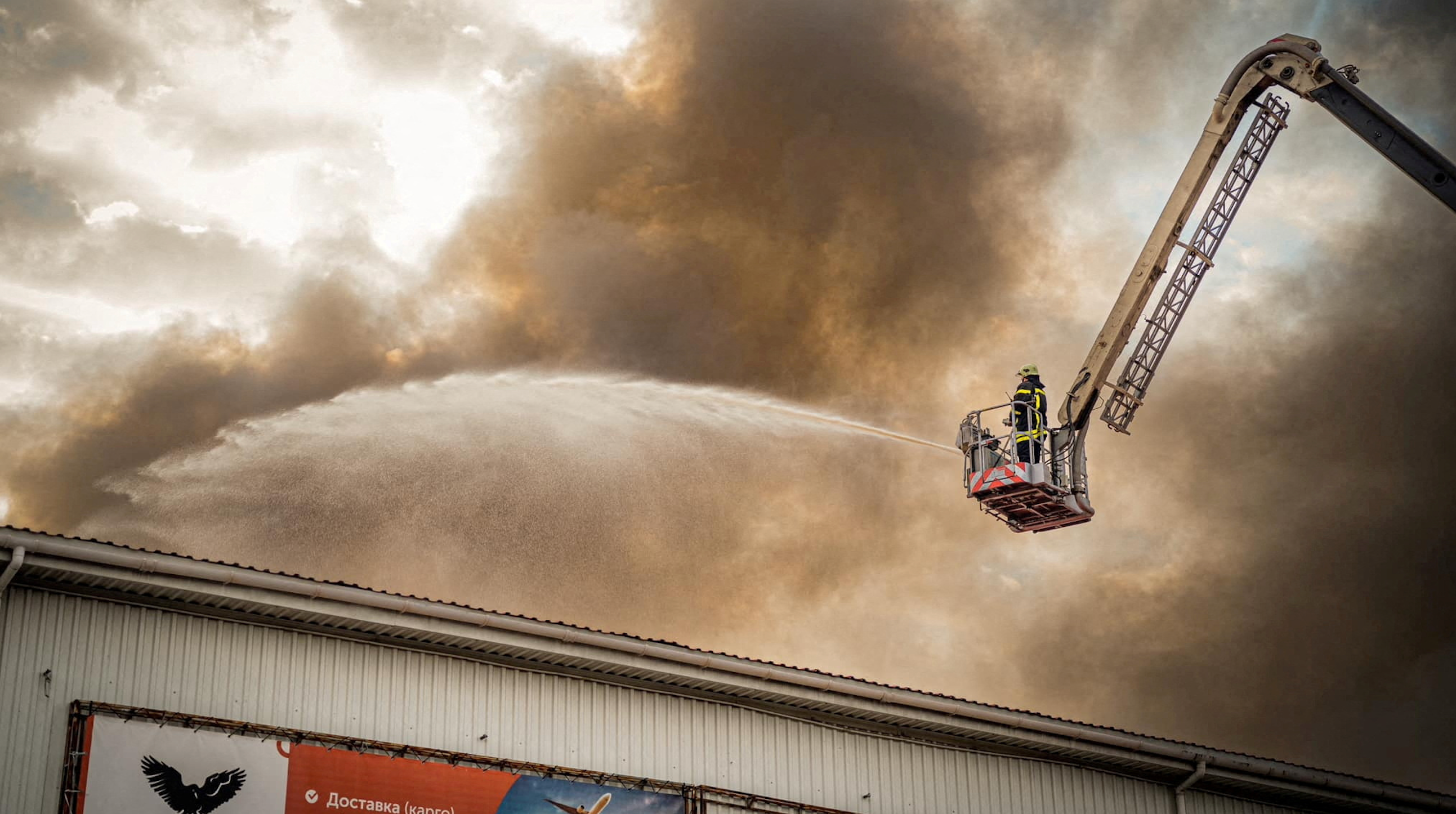 A firefighter works at a site of storage facilities hit during Russian missile and drone strikes