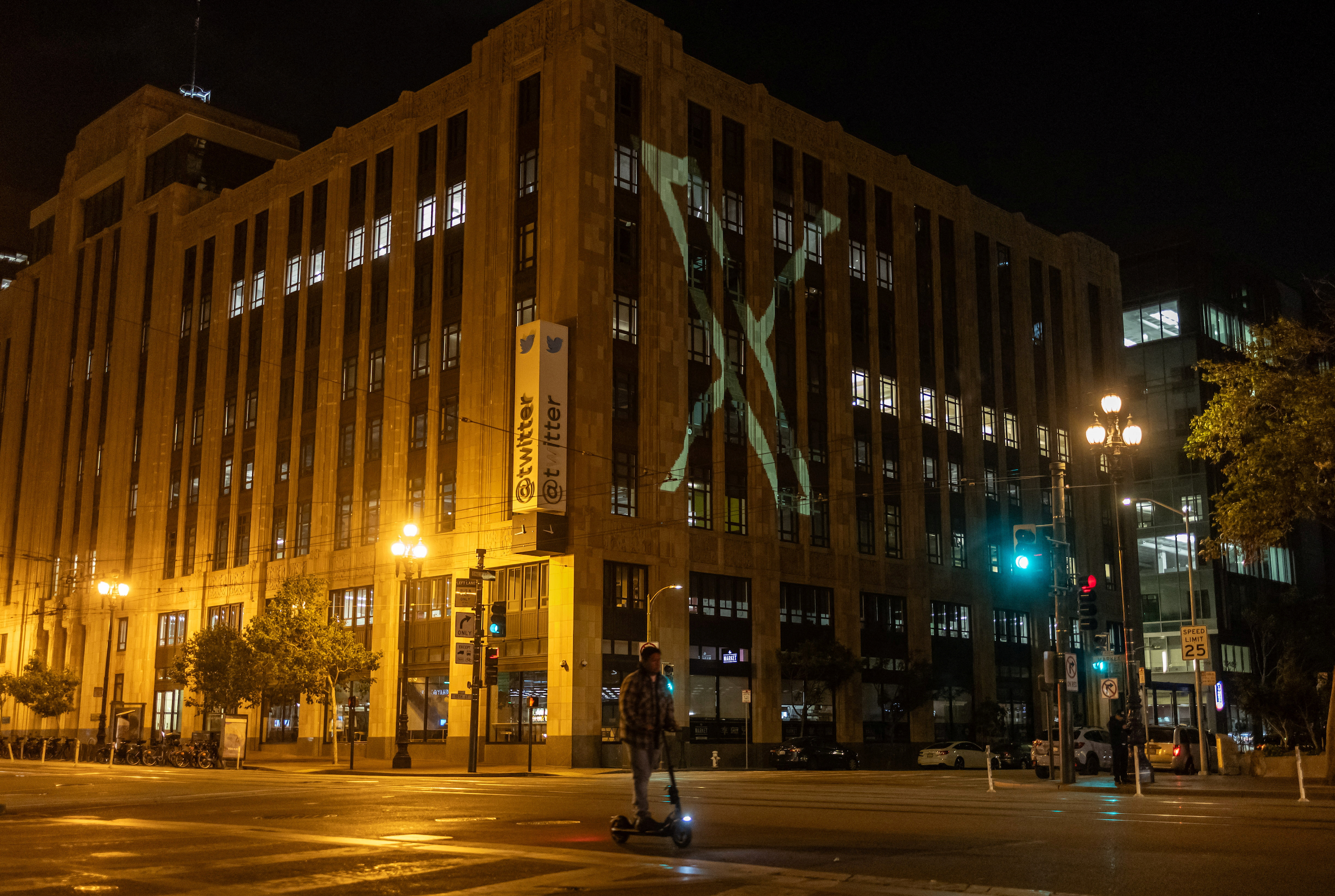 Twitter's new logo is seen projected on the corporate headquarters building in downtown San Francisco, California