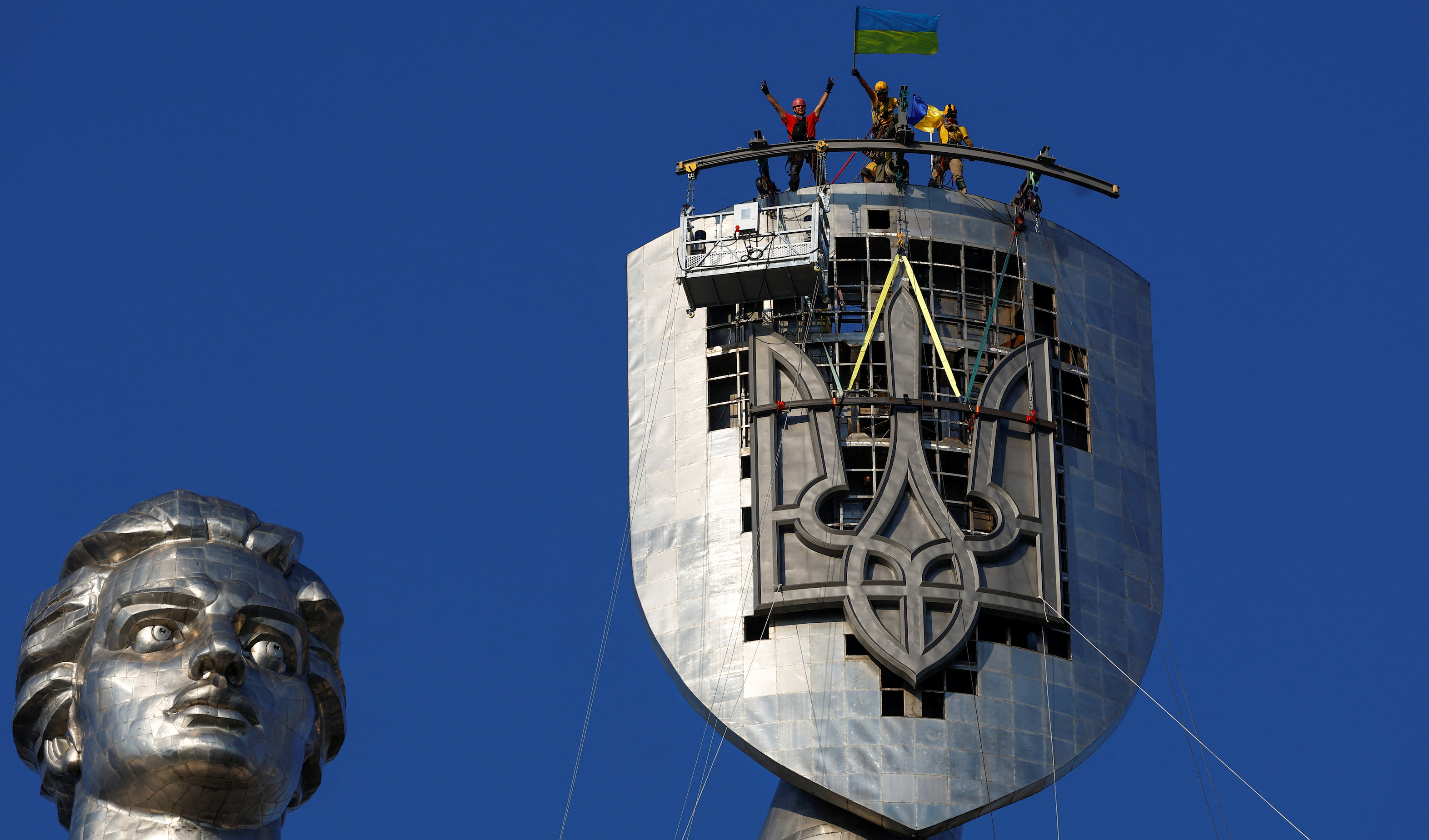 Ukraine removes Soviet symbols from Motherland monument in Kyiv