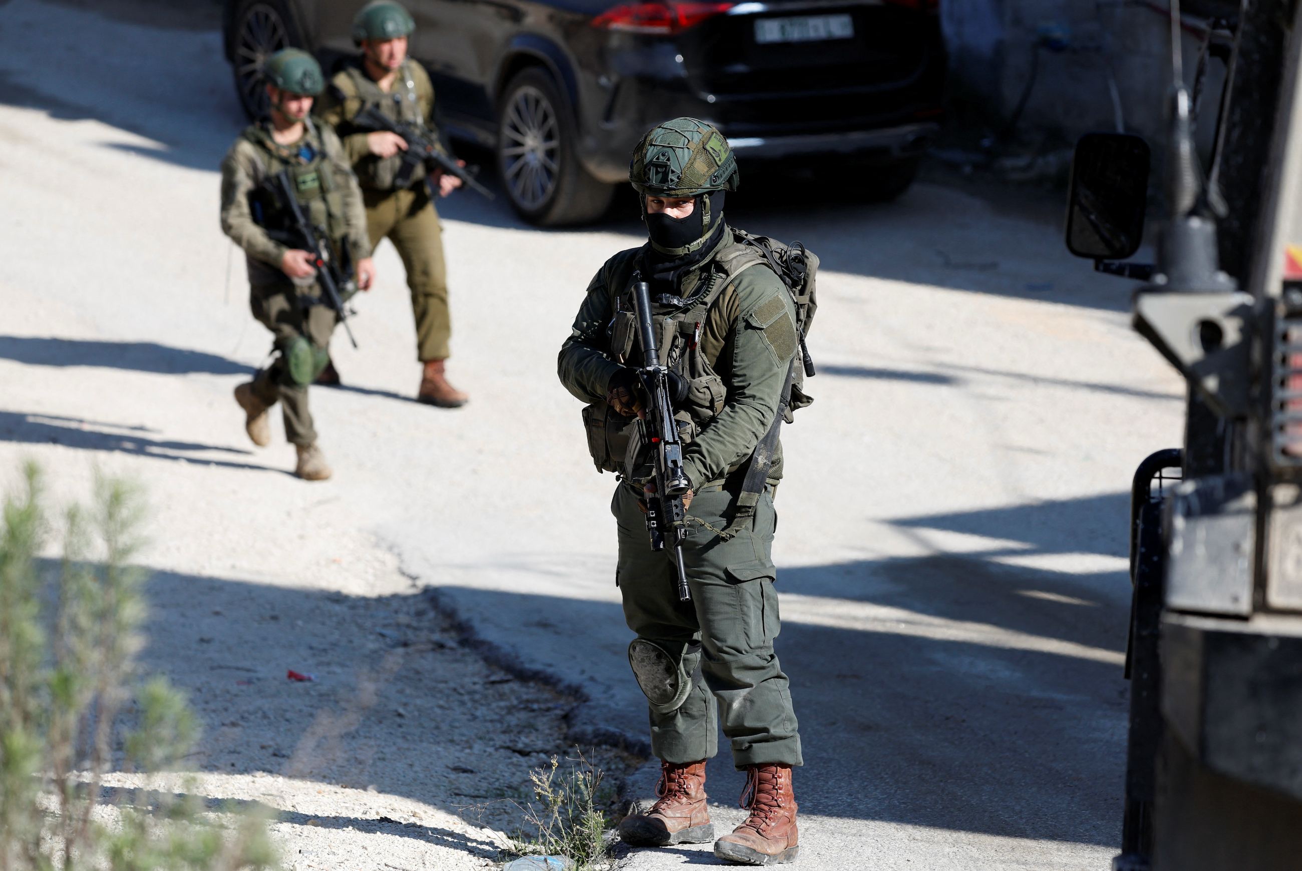 Israeli settlers attack two Palestinian towns and Israeli troops in West Bank