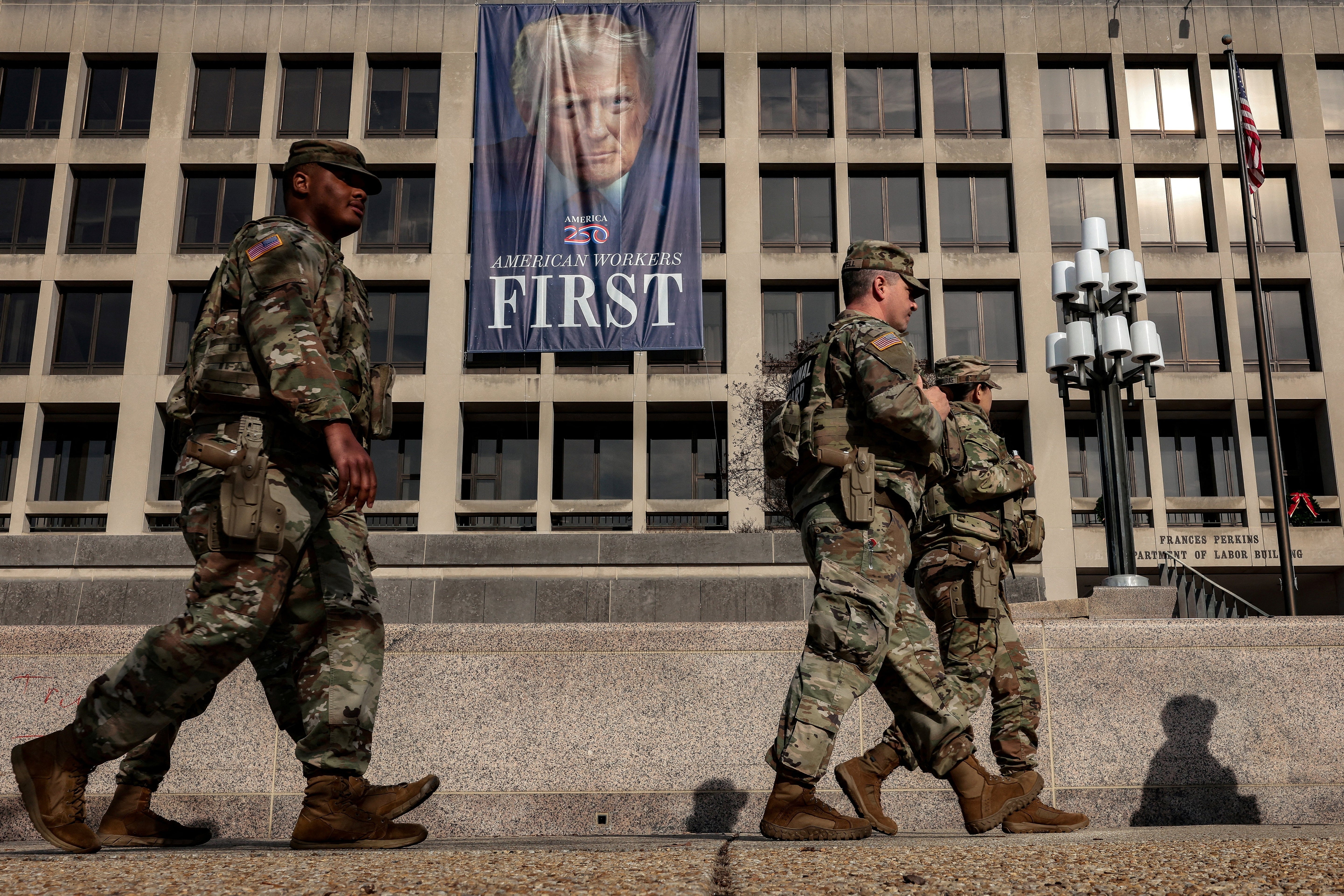 Members of the National Guard walk past the U.S. Department of Labor, which published its weekly initial jobless claims report for the week ending January 3, in Washington, D.C., U.S., January 8, 2026. REUTERS/Evelyn Hockstein