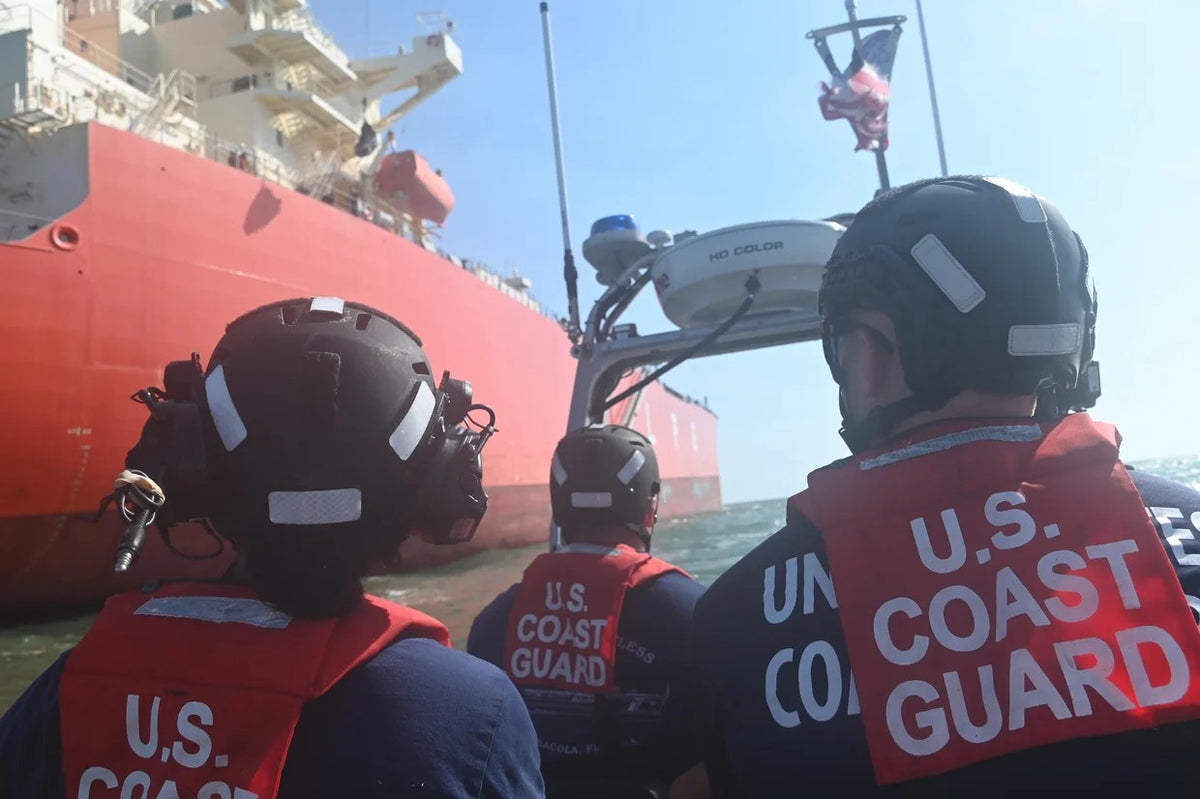 U.S. Coast Guard personnel board a Texas-bound commercial oil tanker in the Atlantic in August 2026 during an investigation into a possible overseas cyber intrusion. The boarding team included Coast Guard law-enforcement and cybersecurity personnel, a