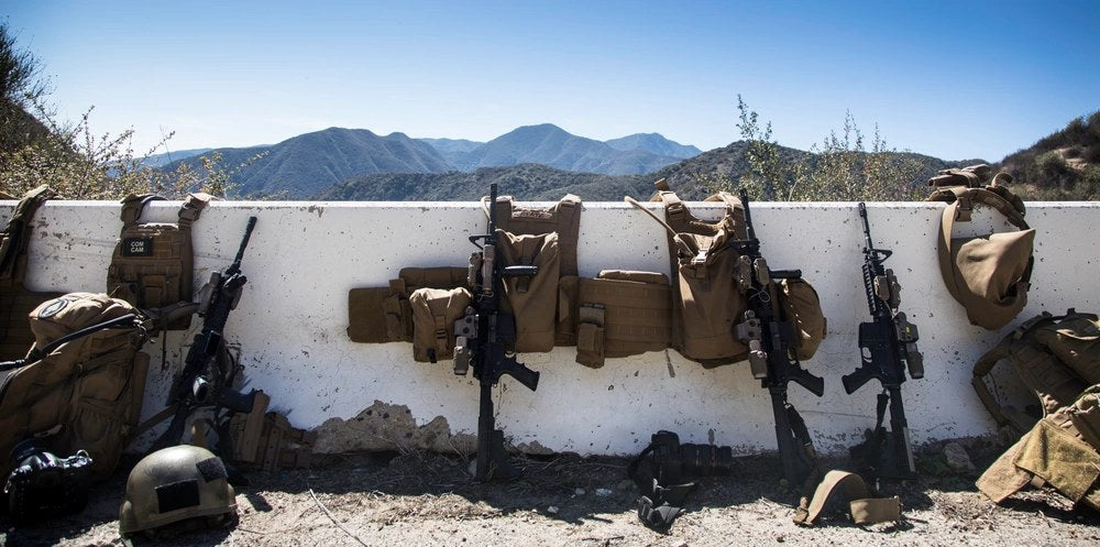 Weapons and body armor used by Army, Navy and Marine Corps personnel sit staged during Fleet Combat Camera Pacific’s Winter Quick Shot exercise in California, March 8, 2014. U.S. Army photo by Spc. Philip Diab.