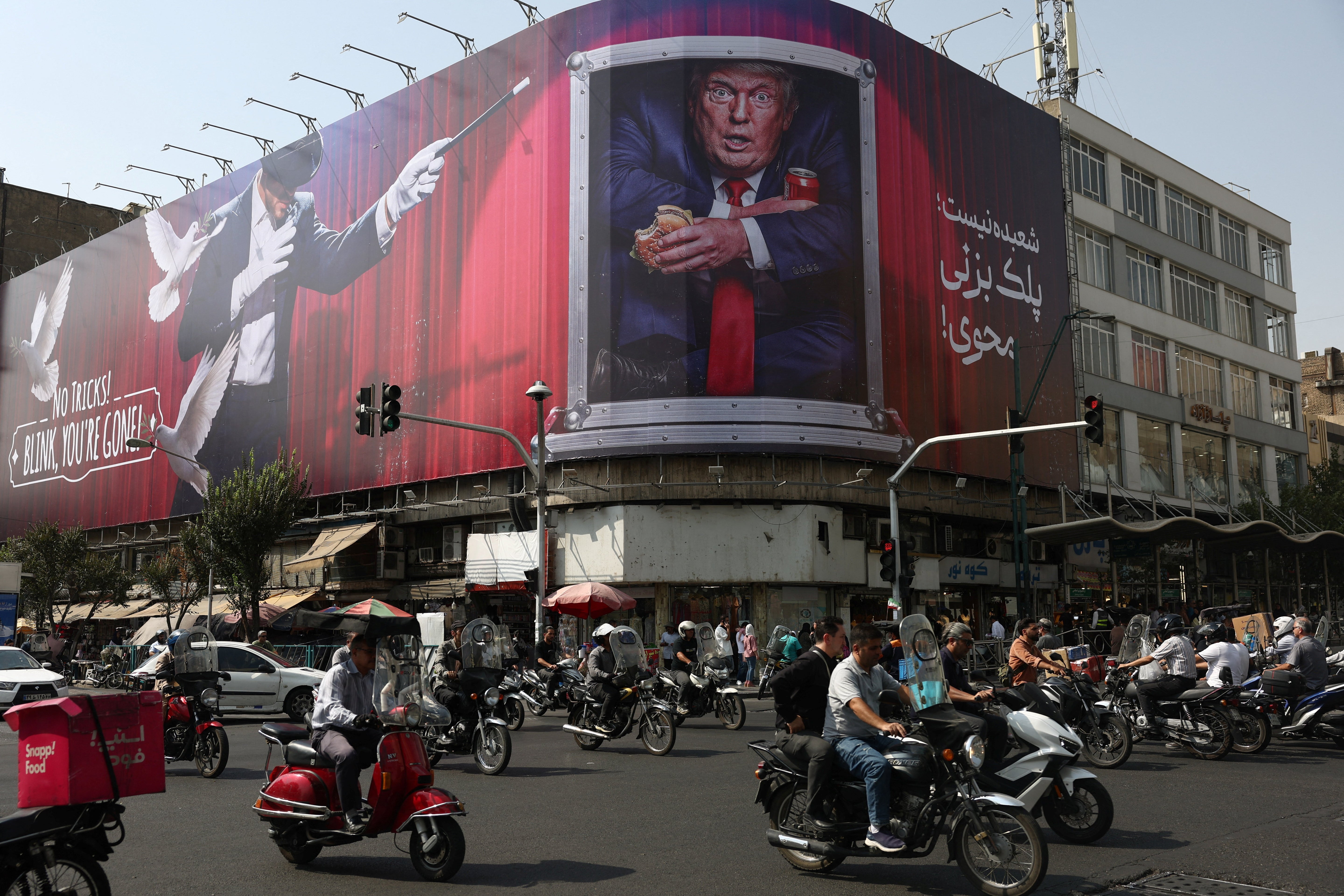 People drive near a billboard depicting U.S. President Donald Trump on a building in Tehran, Iran, August 31, 2026. Majid Asgaripour/WANA (West Asia News Agency) via REUTERS