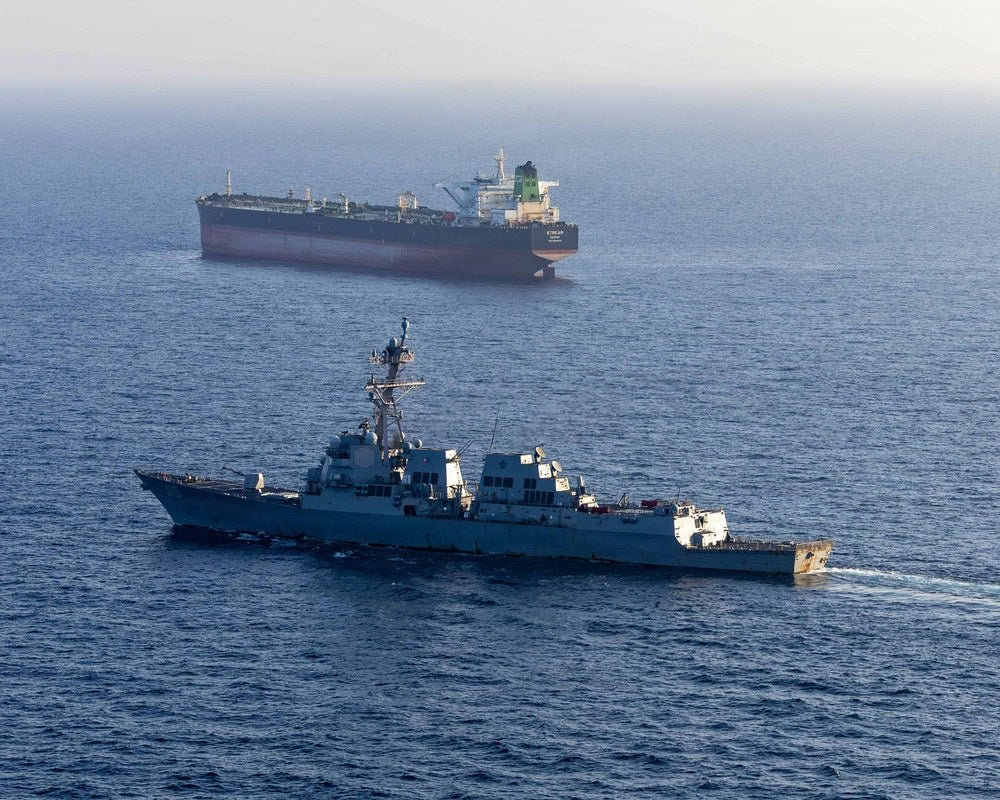 The guided-missile destroyer USS Rafael Peralta operates near an Iranian-flagged commercial vessel while enforcing the U.S. maritime blockade against Iran, April 26, 2026. CENTCOM said Oct. 5 that U.S. forces have destroyed 13 commercial vessels,