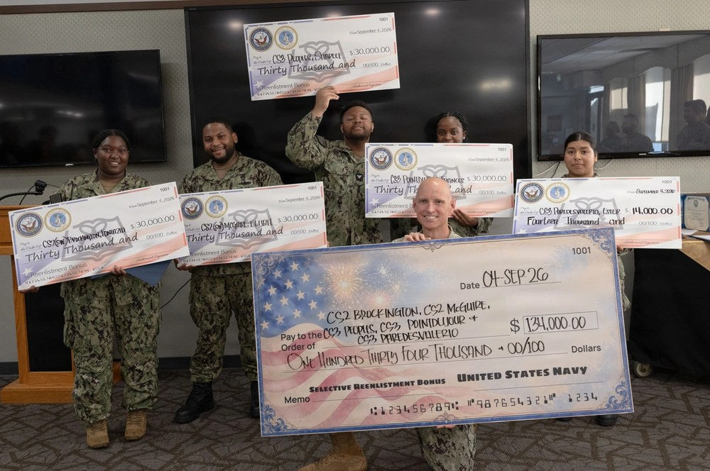 U.S. Navy Culinary Specialists display Selective Reenlistment Bonus checks during a ceremony at Naval Base San Diego, Sept. 3, 2026. Navy reenlistment bonus changes taking effect Oct. 8 will reduce 212 bonus levels and eliminate 16 others, according to a