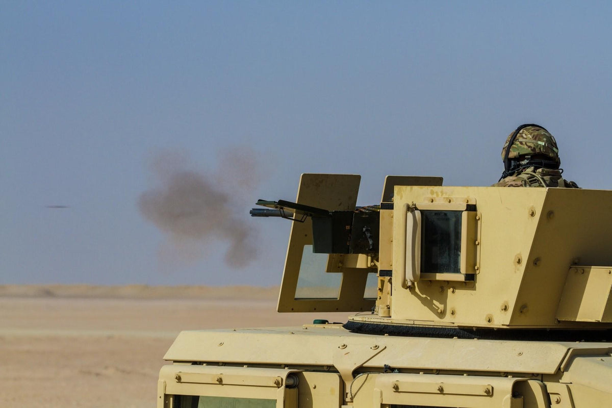 A U.S. Marine fires a .50-caliber machine gun during a training exercise at Camp Buehring, Kuwait, in October 2021. Newly published reporting says American soldiers defending the same installation ran critically low on .50-caliber ammunition during
