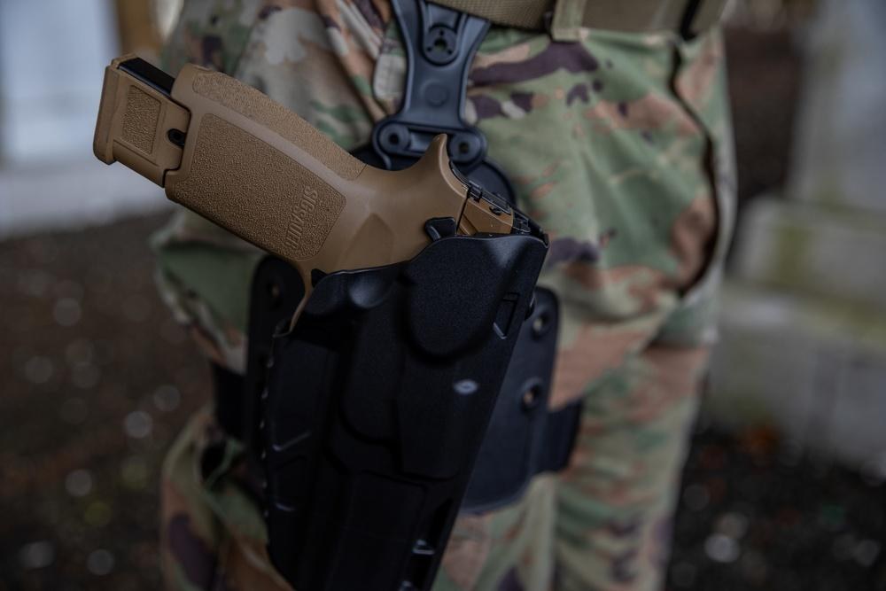 An M17 service pistol is secured in a National Guard soldier's holster during training in Connecticut on April 8, 2022. A new federal lawsuit challenges Pennsylvania's minimum age of 21 for obtaining a firearm carry license, which is generally required