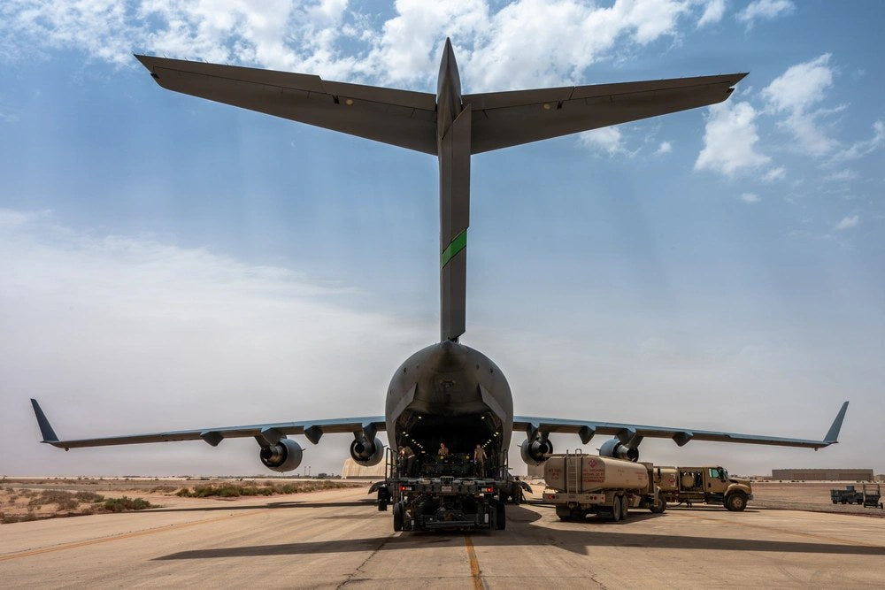 U.S. Air Force Airmen load cargo aboard a C-17 Globemaster III at a Middle East base during Operation Epic Fury, April 18, 2026. The former commander of Air Forces Central says shortcomings in the munitions logistics system early in the war forced him to