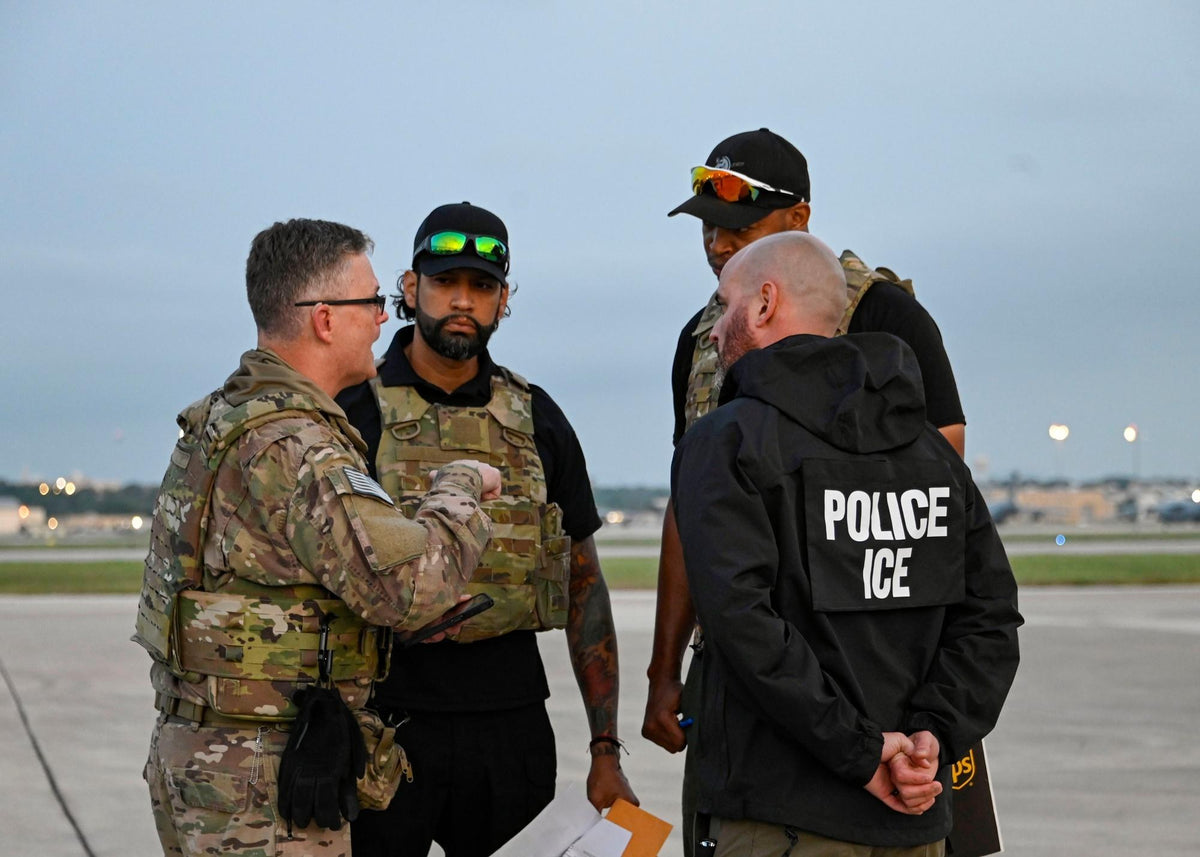 An Army officer reviews documents with an ICE deportation officer during federal immigration removal operations in May 2025. A federal judge has since blocked the Trump administration's expanded immigration fine system. U.S. Air Force photo by Staff Sgt.