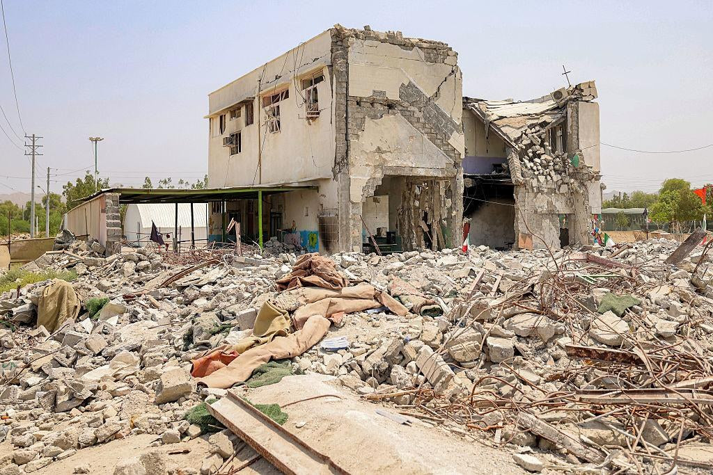 The aftermath of the February 28, 2026, missile strike on Shajareh Tayyebeh Elementary School in Minab, Iran. Bloomberg reports that Pentagon officials intend to delay releasing the investigation's findings until after the November midterm elections.
