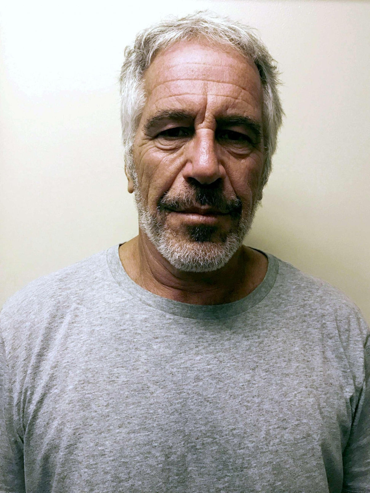 Jeffrey Epstein is pictured in a July 2019 Federal Bureau of Prisons photograph. A new CBS News investigation identified references to classified materials and significant gaps in the Justice Department's publicly released Epstein files, raising