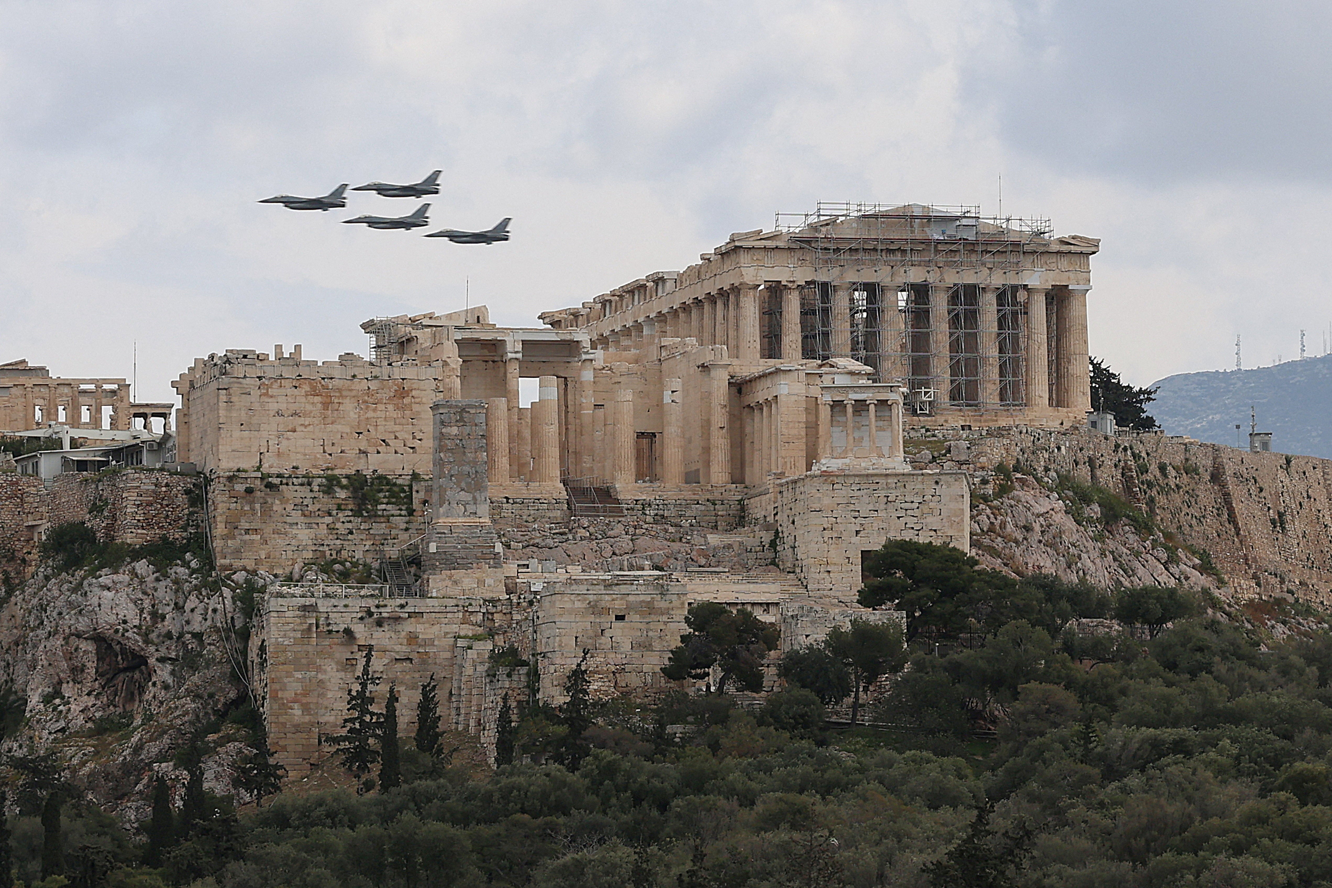 FILE PHOTO: Military planes fly above the Acropolis of Athens, as part of a military parade marking the country’s Independence Day, in Athens, Greece, March 25, 2026. REUTERS/Louisa Gouliamaki/File Photo