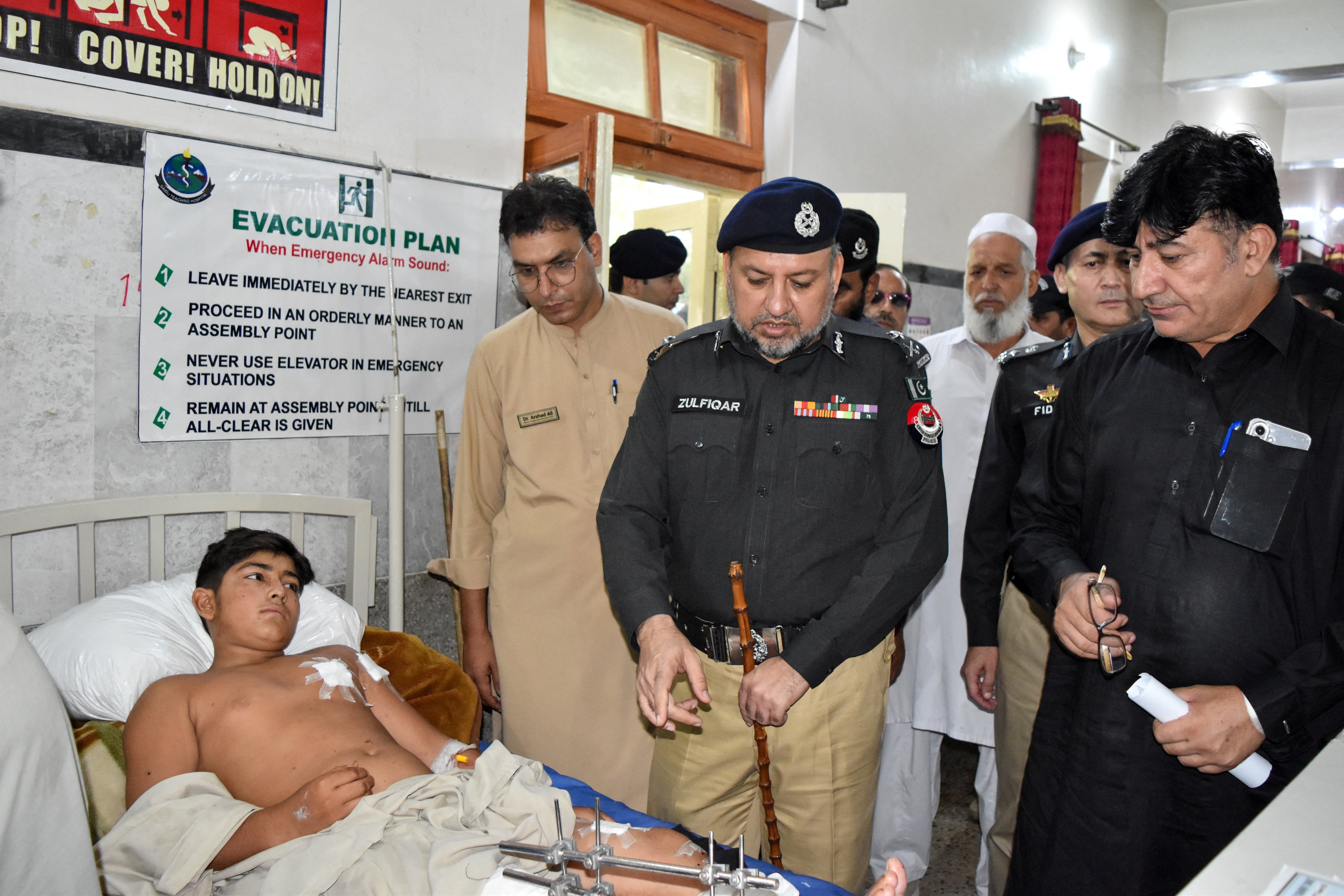 Inspector General of Police (IGP) Zulfiqar Hameed visits a boy who was among those injured in a suspected suicide bombing outside a police station, at a hospital in Swat district of Pakistan's Khyber Pakhtunkhwa province, Pakistan, August 3, 2026.