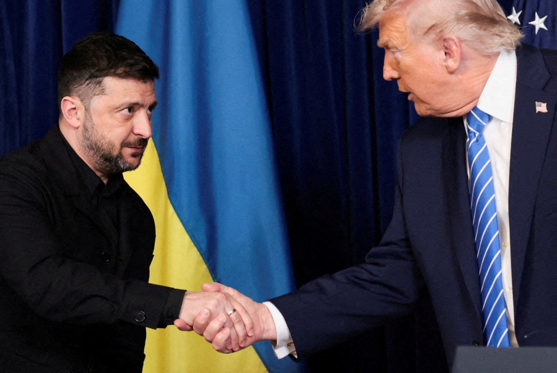 FILE PHOTO: U.S. President Donald Trump and Ukrainian President Volodymyr Zelenskiy shake hands during a press conference after their lunch meeting at Trump?s Mar-a-Lago club, in Palm Beach, Florida, U.S., December 28, 2025. REUTERS/Jonathan Ernst/File