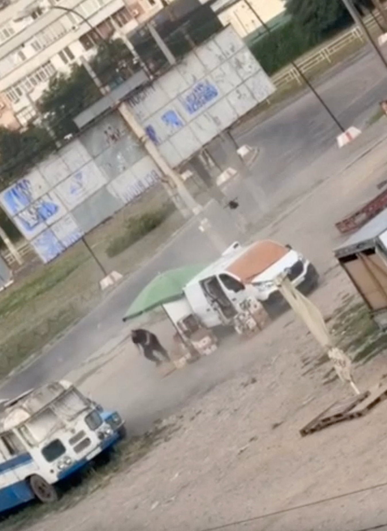 A drone circles over a man at a market in Kherson, southern Ukraine, before detonating nearby, in an incident that Ukrainian authorities said occurred on August 4, 2026, amid Russia's attack on Ukraine, in this still image obtained from a handout video