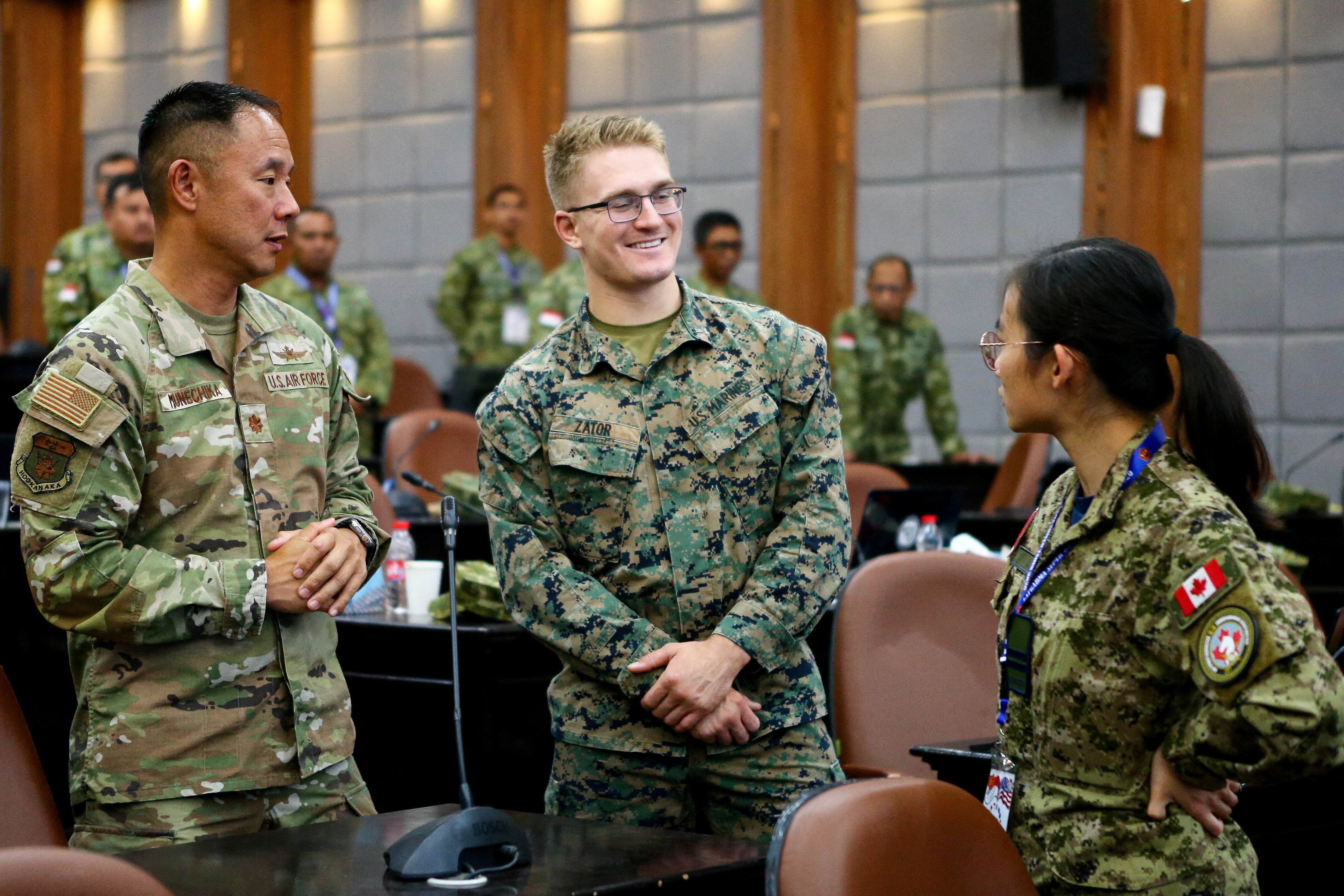 A member of the Canadian Armed Forces speaks with members of the U.S. Armed Forces during the opening ceremony of Super Garuda Shield, an annual joint military exercise involving Indonesia, U.S., and several other nations, in Bandung, West Java province,