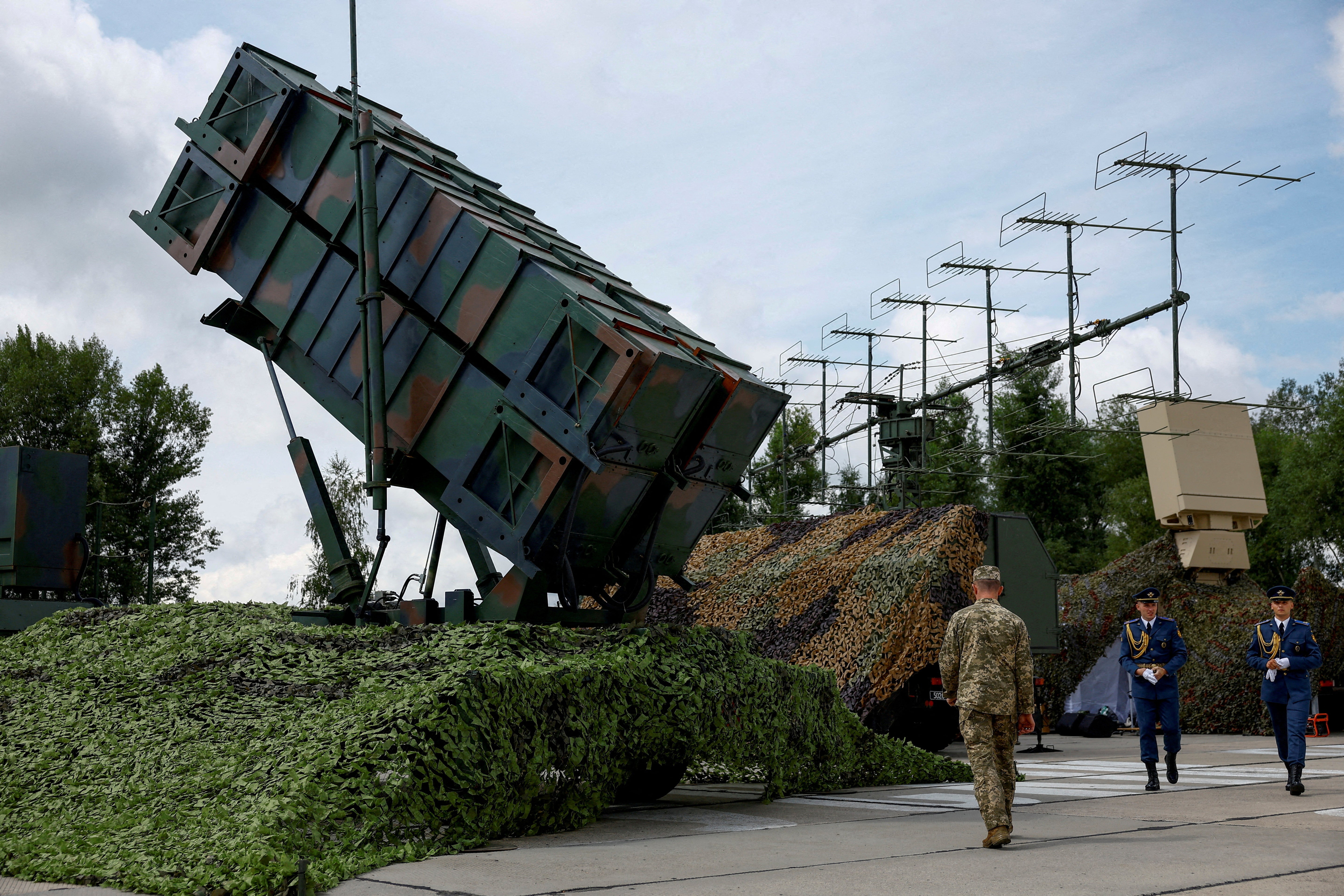 FILE PHOTO: FILE PHOTO: Ukrainian service members walk next to a launcher of a Patriot air defence system, amid Russia's attack on Ukraine, in an undisclosed location, Ukraine August 4, 2024. REUTERS/Valentyn Ogirenko/File Photo