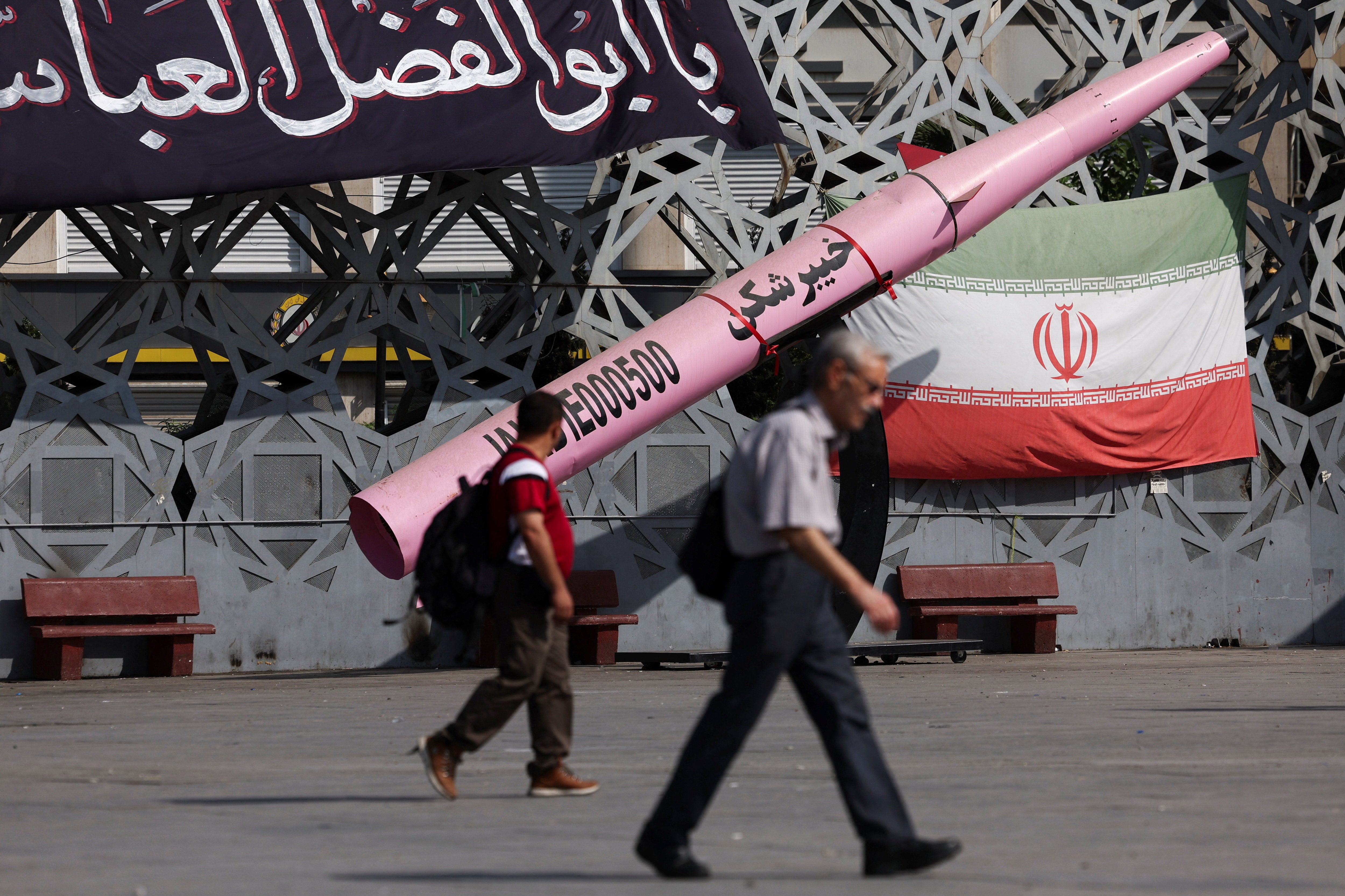 People walk next to a symbolic mockup of an Iranian missile and an Iranian flag at Imam Hussein Square in Tehran, Iran, July 12, 2026. Majid Asgaripour/WANA (West Asia News Agency) via REUTERS