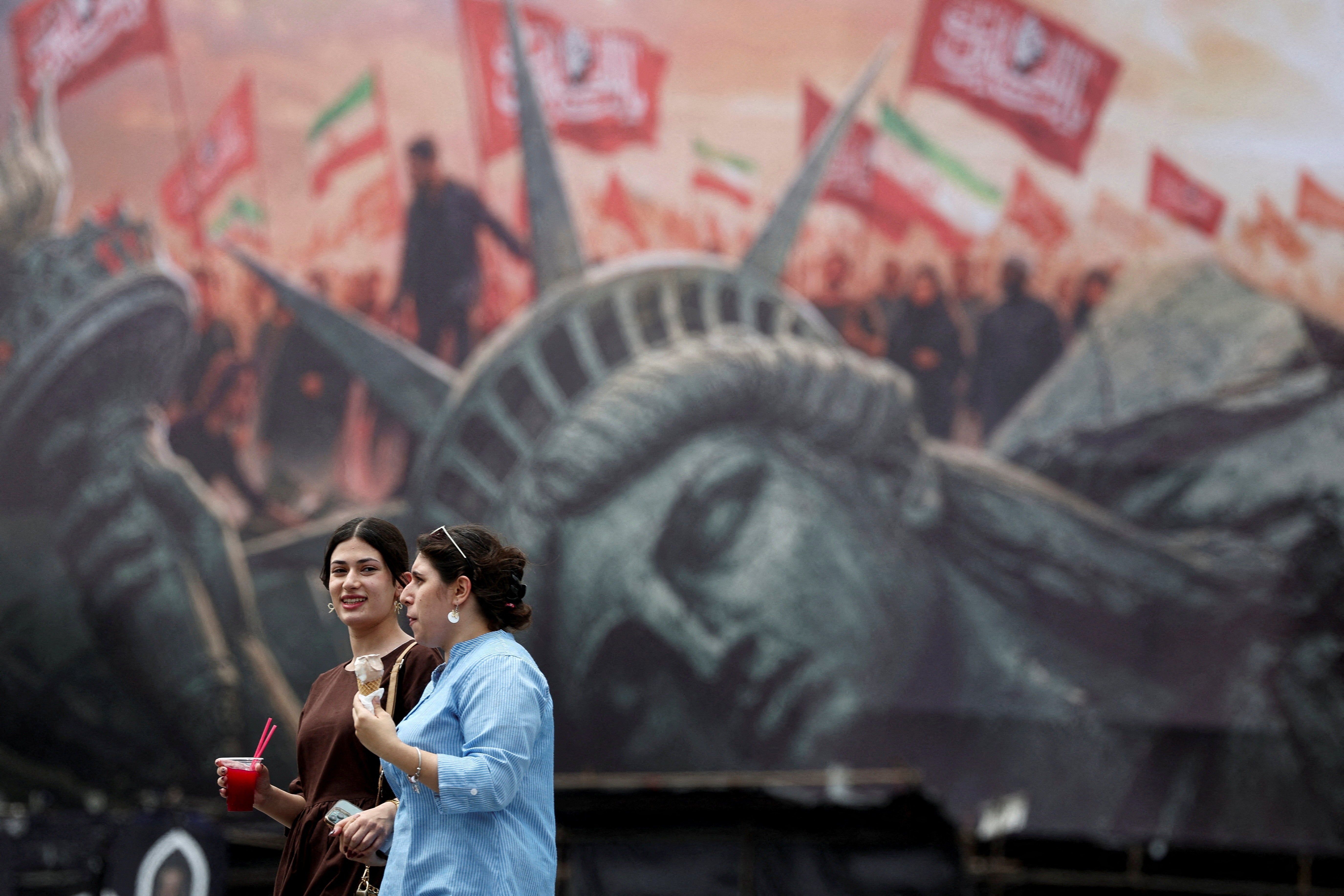 People walk past an anti-U.S. billboard on a street in Tehran, Iran, August 3, 2026. Majid Asgaripour/WANA (West Asia News Agency) via REUTERS