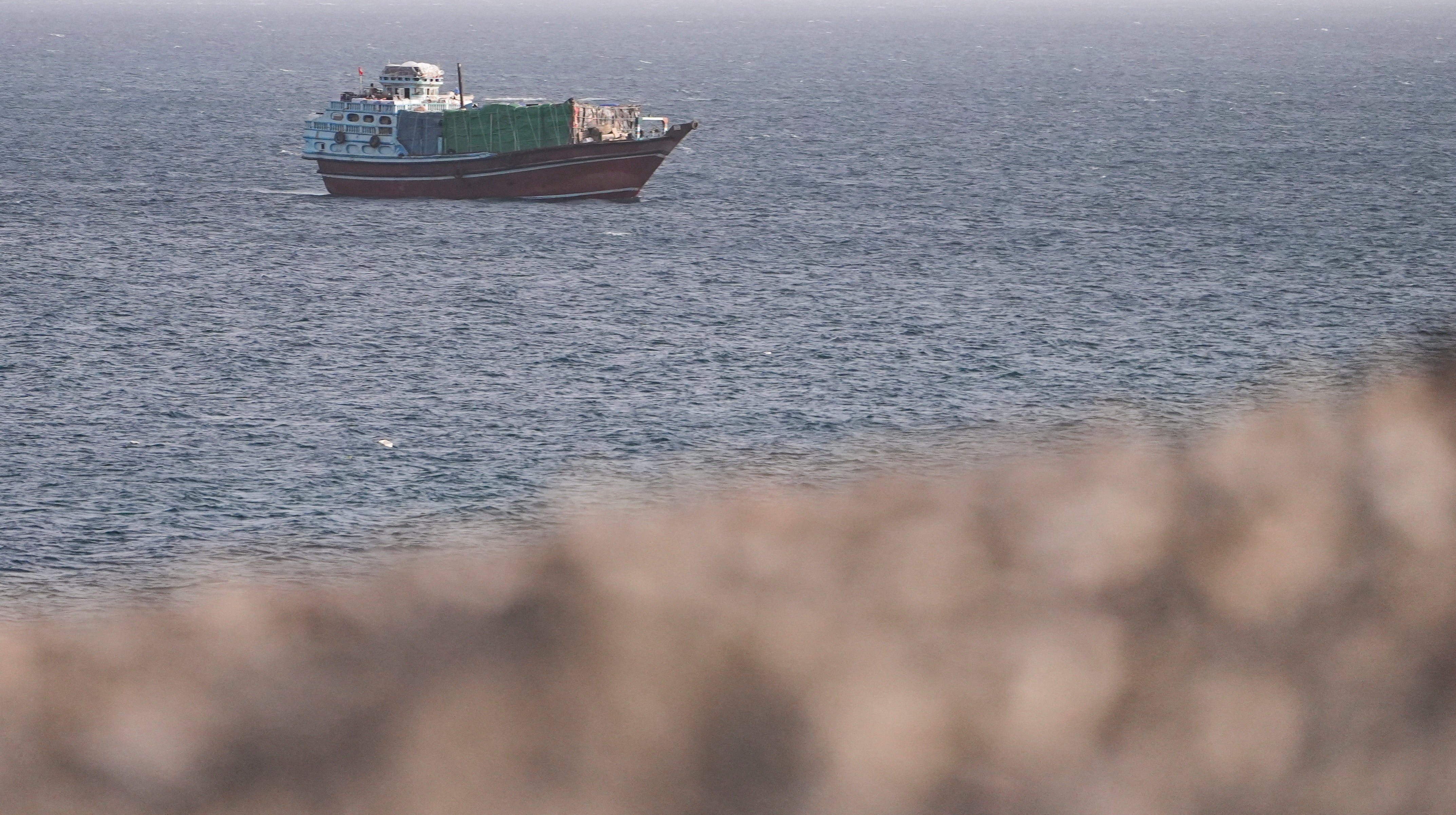 FILE PHOTO: A vessel in the Strait of Hormuz, as seen from Musandam,Oman, July 16, 2026. REUTERS/Stringer/File Photo