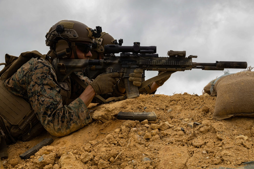 A U.S. Marines with Battalion Landing Team 2/1, 31st Marine Expeditionary Unit, fire their M27 infantry automatic rifle at training targets during a live-fire exercise at Camp Hansen, Okinawa, Japan,