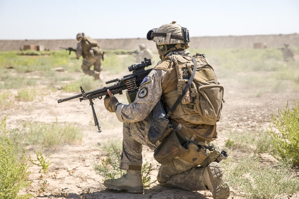 A New Zealand defense force member, with Task Group Taji’s quick reaction force, provides security for bounding teammates during a combined forces live fire exercise at Camp Taji, Iraq