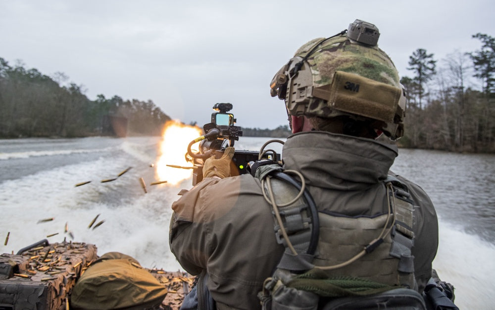 A Swedish special boat unit operator fires the M134 minigun during a joint drill with U.S. Naval Special Warfare Group 4, Stennis Space Center