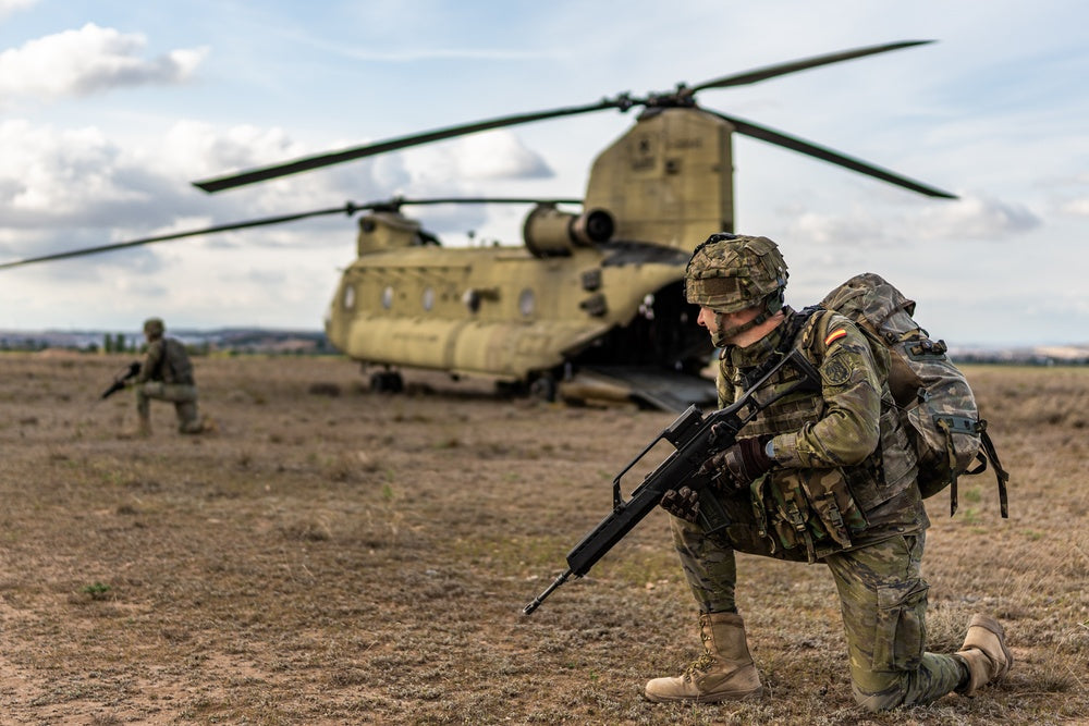 Spanish soldiers secure the perimeter of a U.S. Army CH-47 Chinook