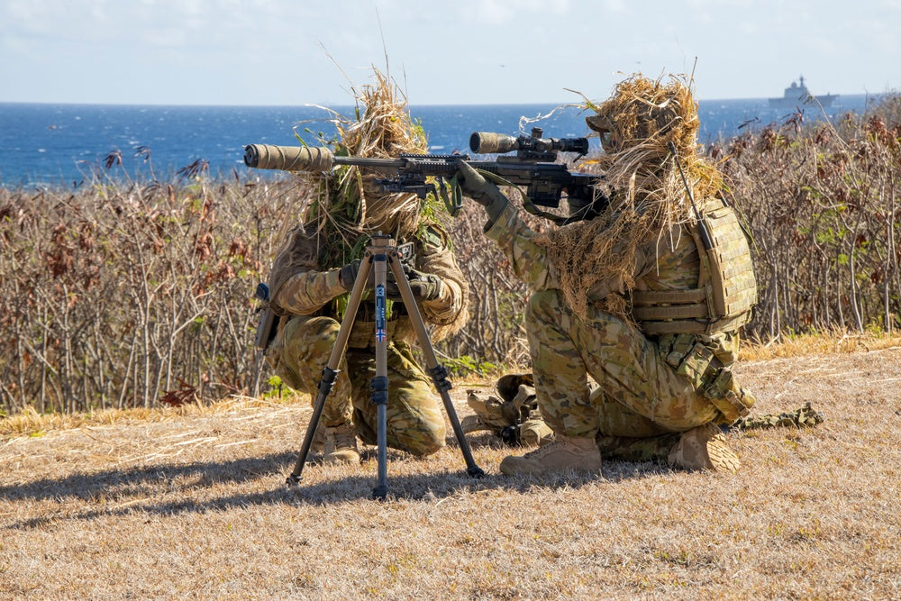 an Australian Army sniper team pull security during an amphibious raid